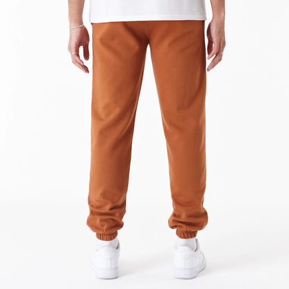 The Male model is wearing New York Yankees League Essential Brown Joggers 4