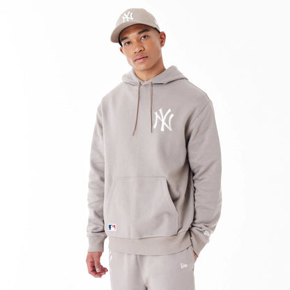 The Male model is wearing New York Yankees League Essential Beige Oversized Pullover Hoodie 10