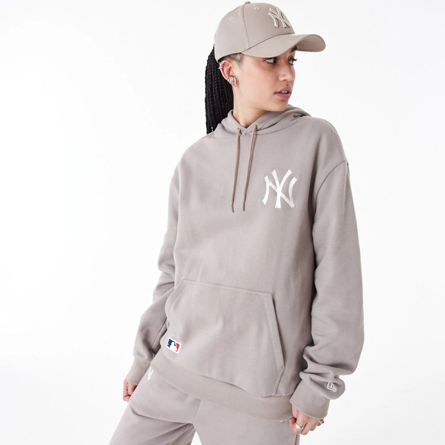 The Male model is wearing New York Yankees League Essential Beige Oversized Pullover Hoodie 9