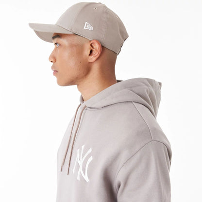 The Male model is wearing New York Yankees League Essential Beige Oversized Pullover Hoodie 8