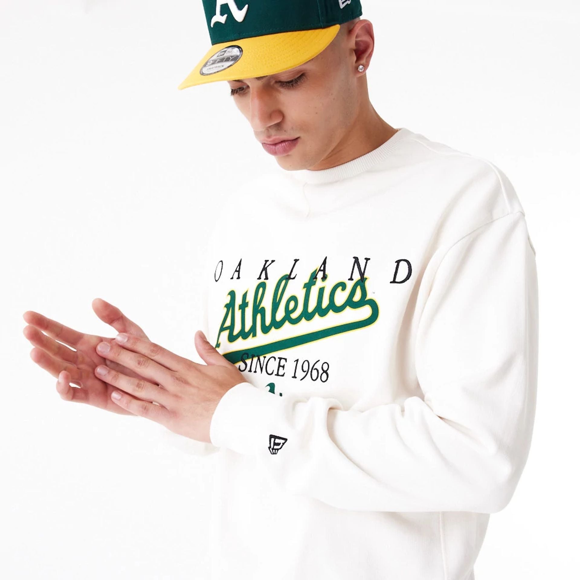 The Male model is wearing Oakland Athletics MLB Lifestyle Off White Crew Neck Sweatshirt 6