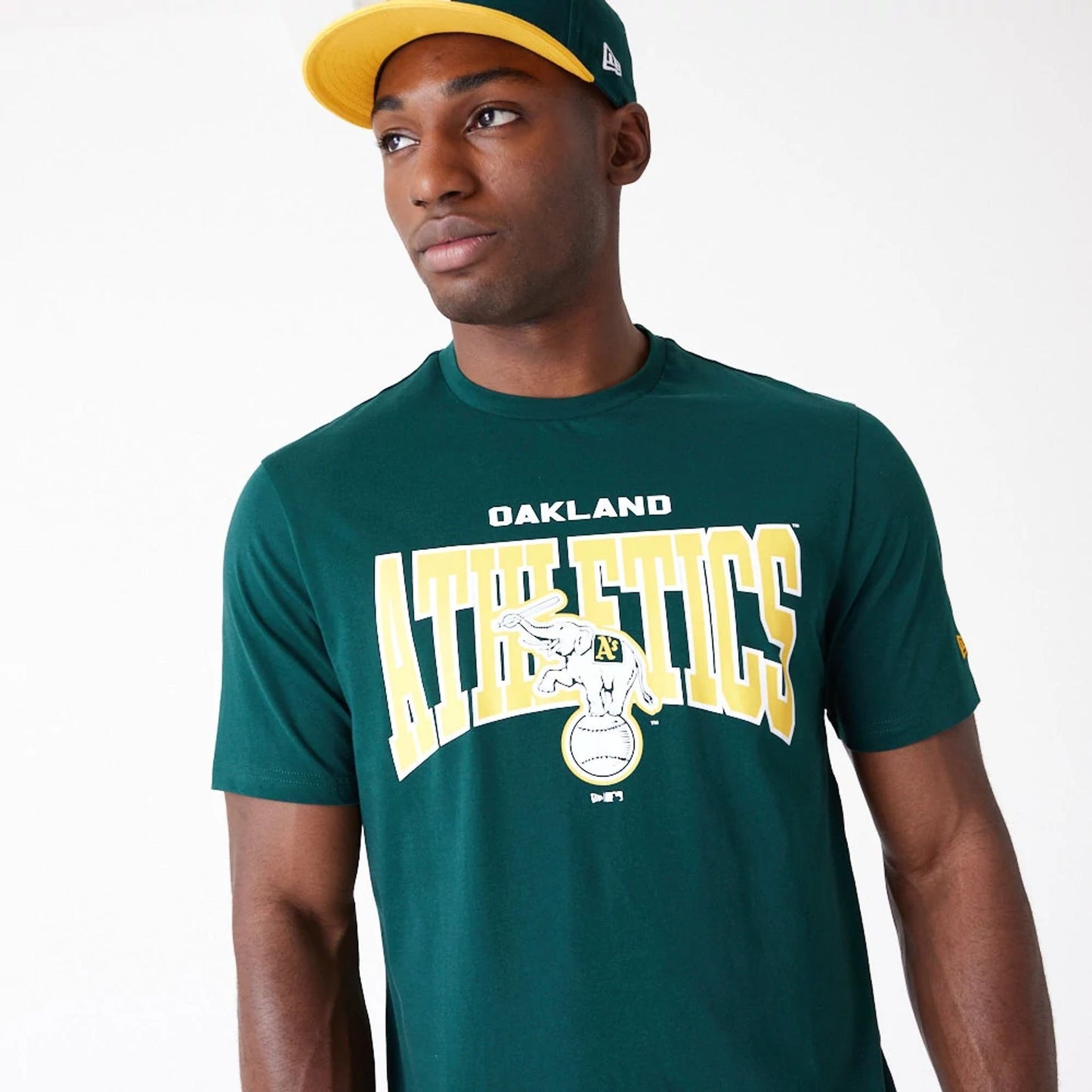 The Male model is wearing Oakland Athletics MLB Arch Wordmark Graphic Dark Green T-Shirt 5