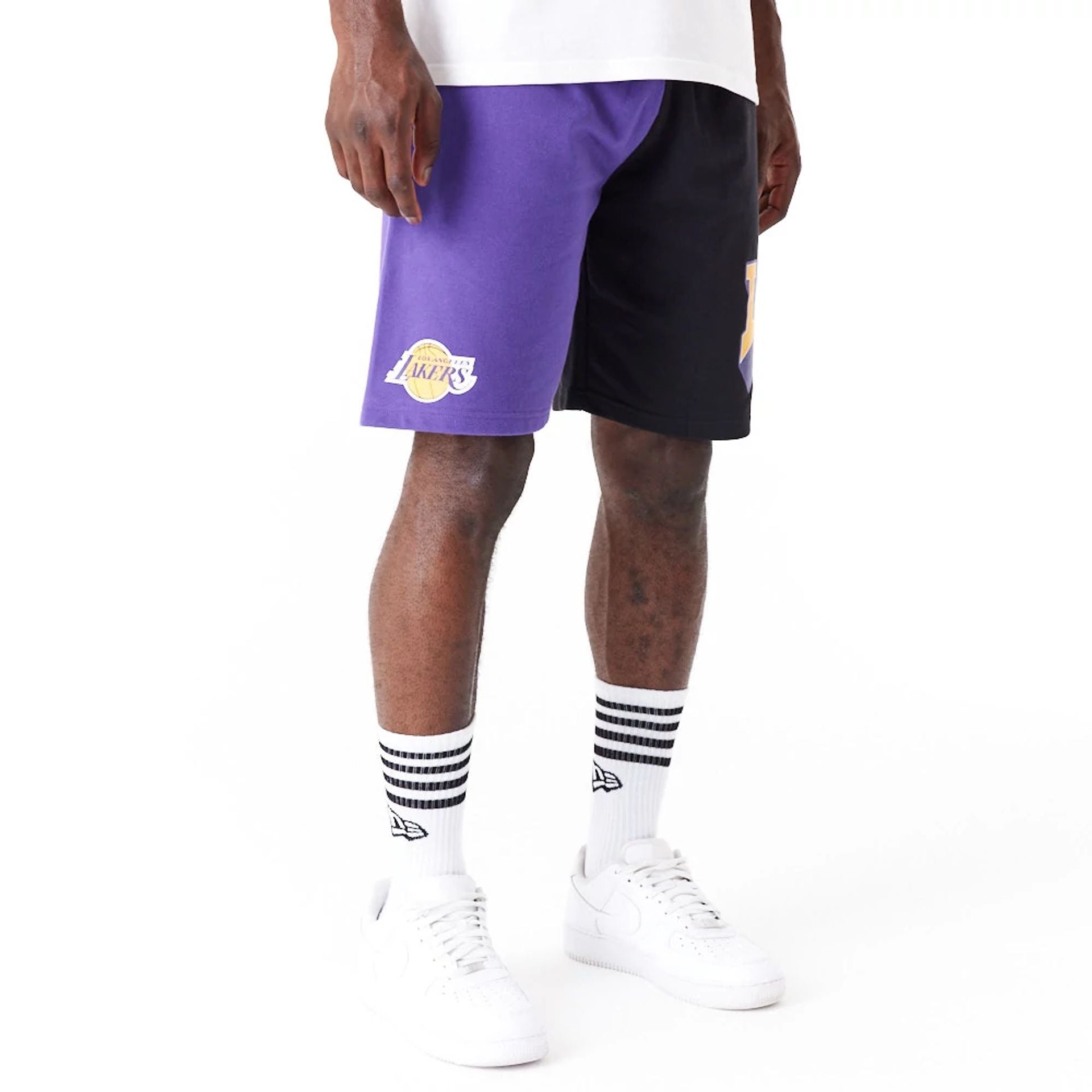 The Male model is wearing LA Lakers NBA Graphic Purple Shorts 2