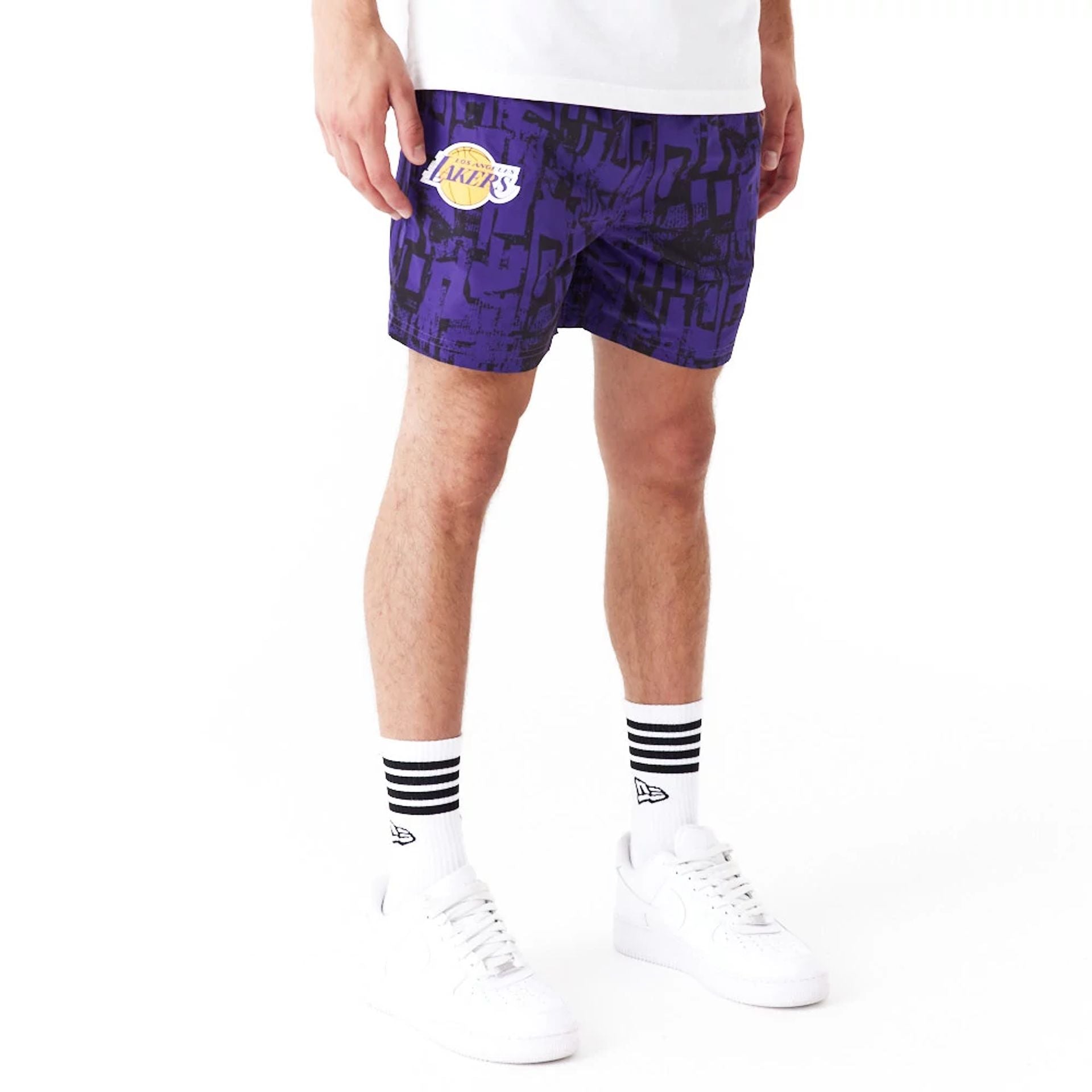 The Male model is wearing LA Lakers NBA All Over Print Purple Shorts 1