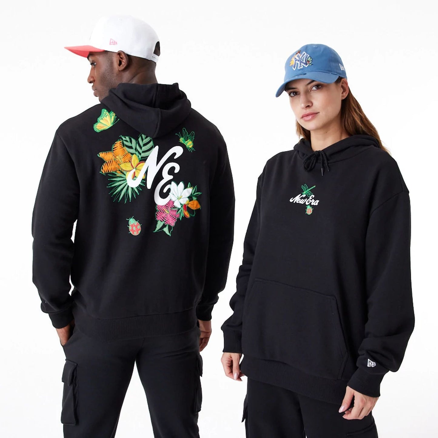 The Male model is wearing New Era Floral Graphic Black Oversized Pullover Hoodie 1