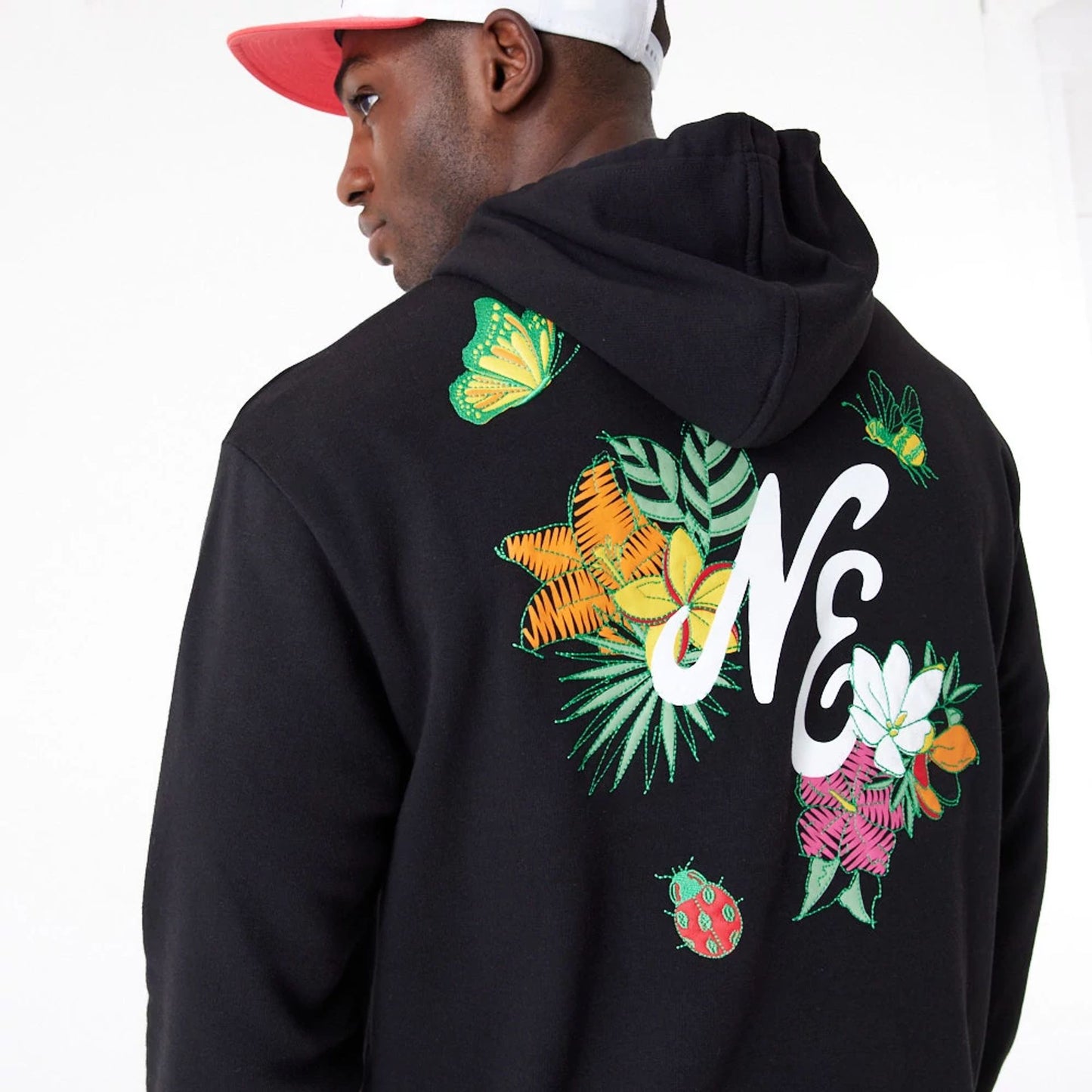 The Male model is wearing New Era Floral Graphic Black Oversized Pullover Hoodie 5