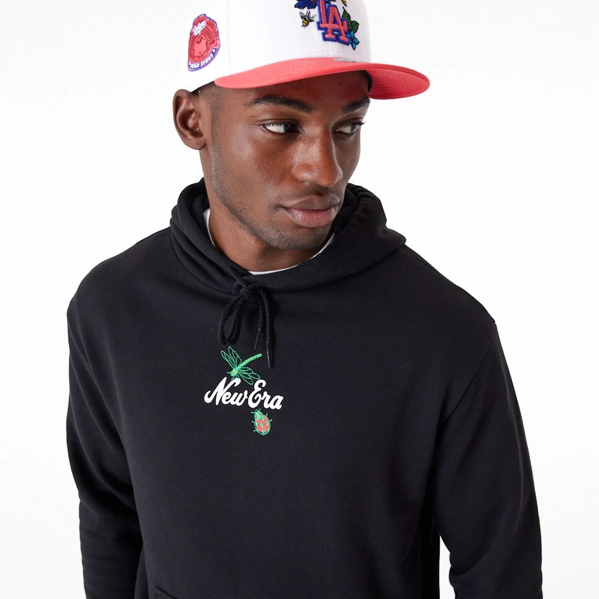 The Male model is wearing New Era Floral Graphic Black Oversized Pullover Hoodie 7