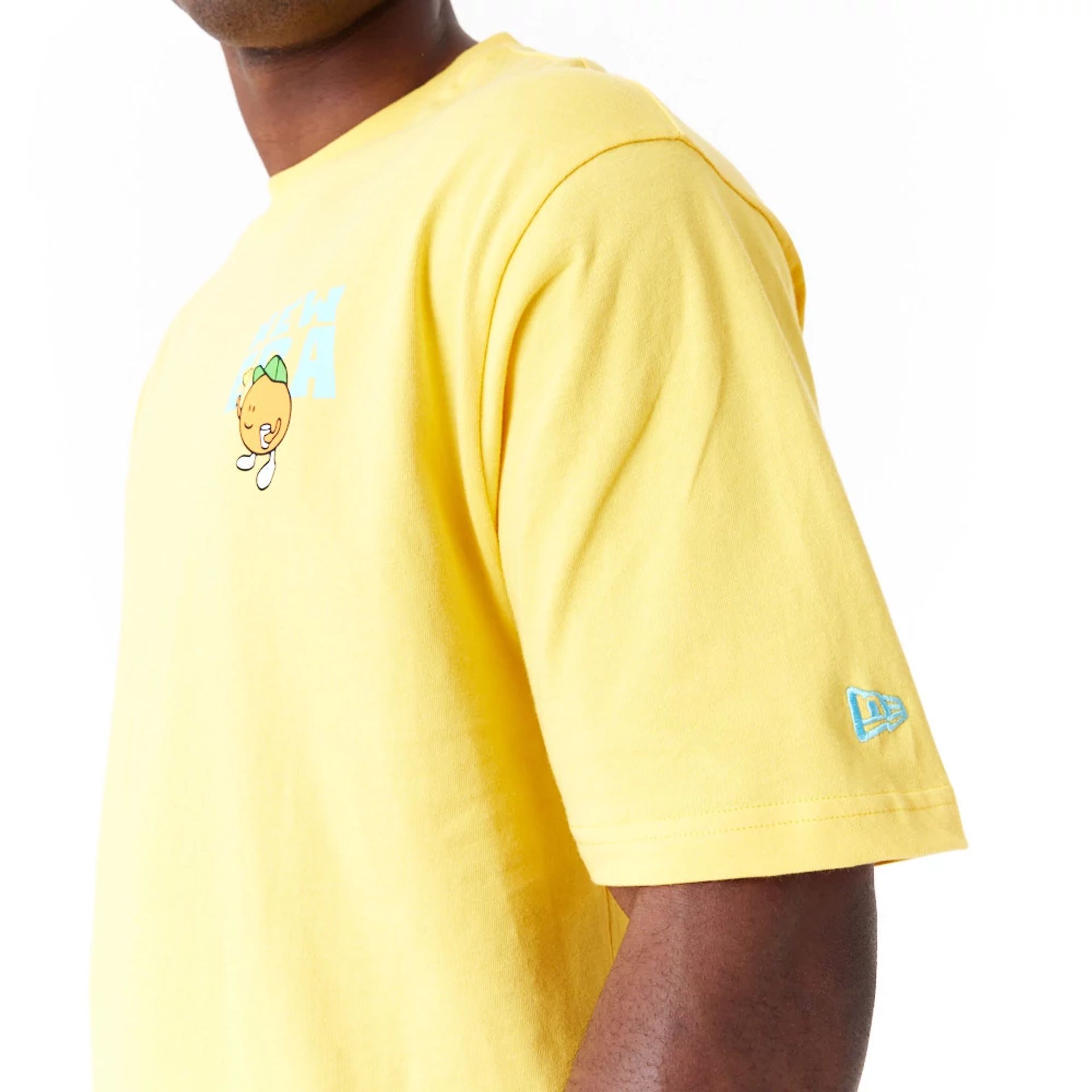 The Male model is wearing New Era Pool Party Fruit Graphic Yellow Oversized T-Shirt 4