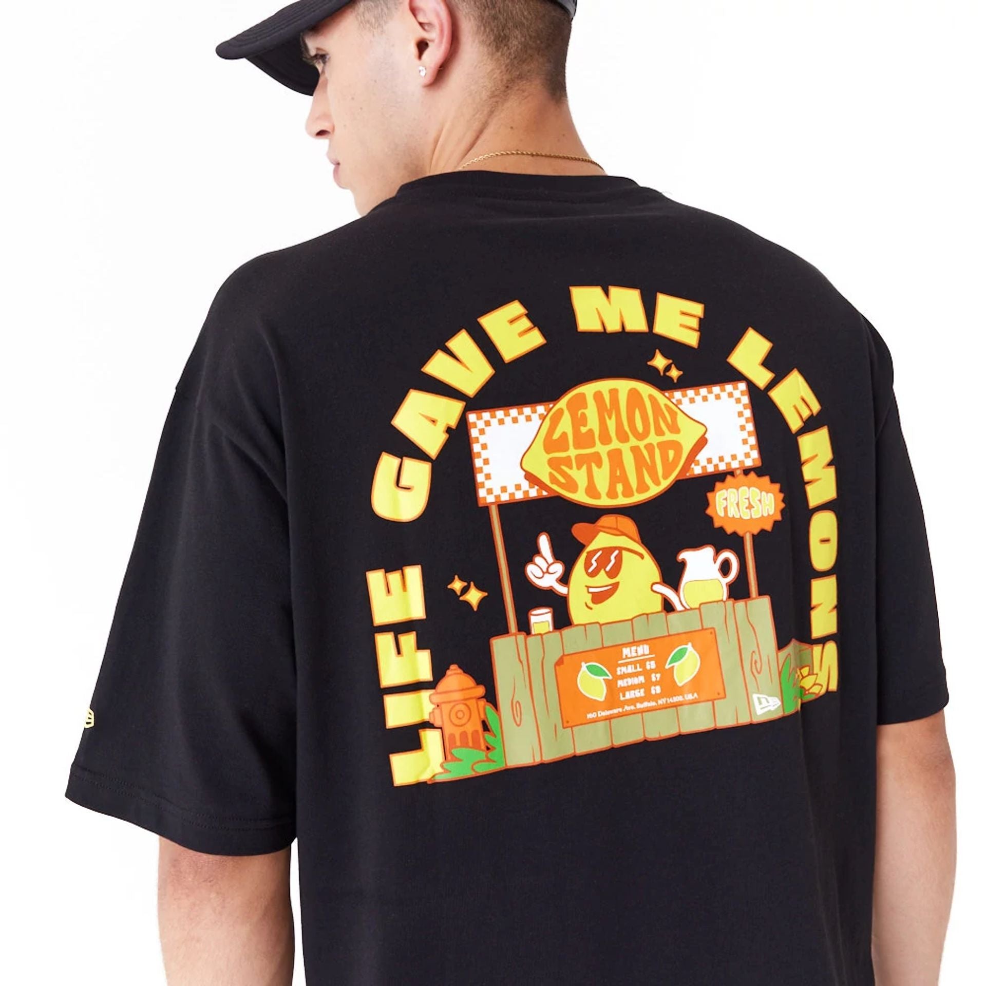 The Male model is wearing New Era Lemon Stand Fruit Graphic Black Oversized T-Shirt 4