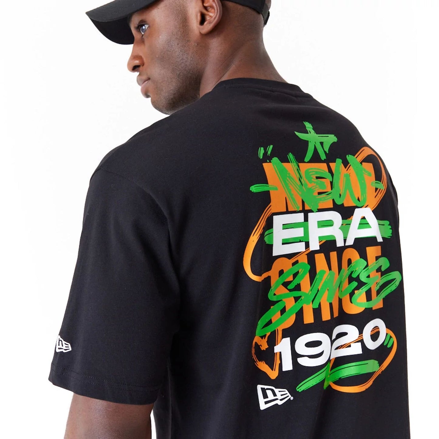 The Male model is wearing New Era Spray Graphic Black Oversized T-Shirt 2