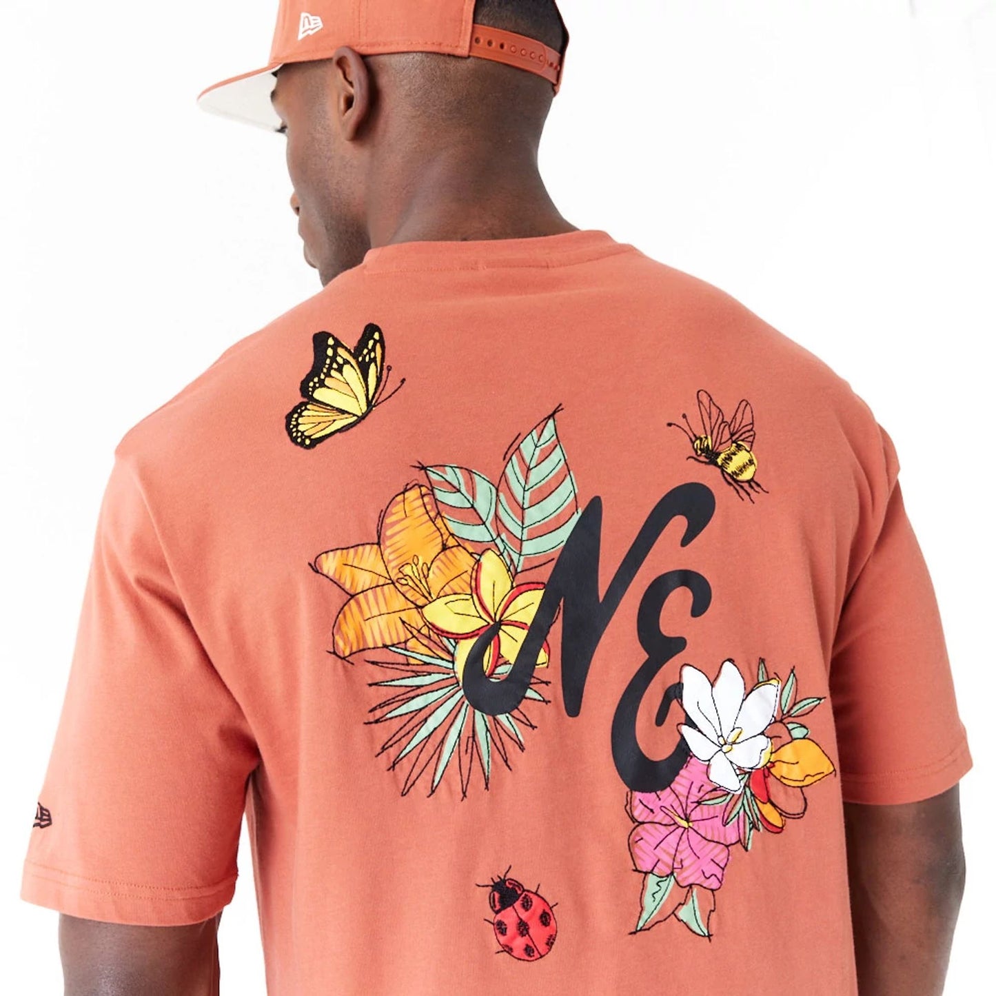 The Male model is wearing New Era Floral Graphic Brown Oversized T-Shirt 2