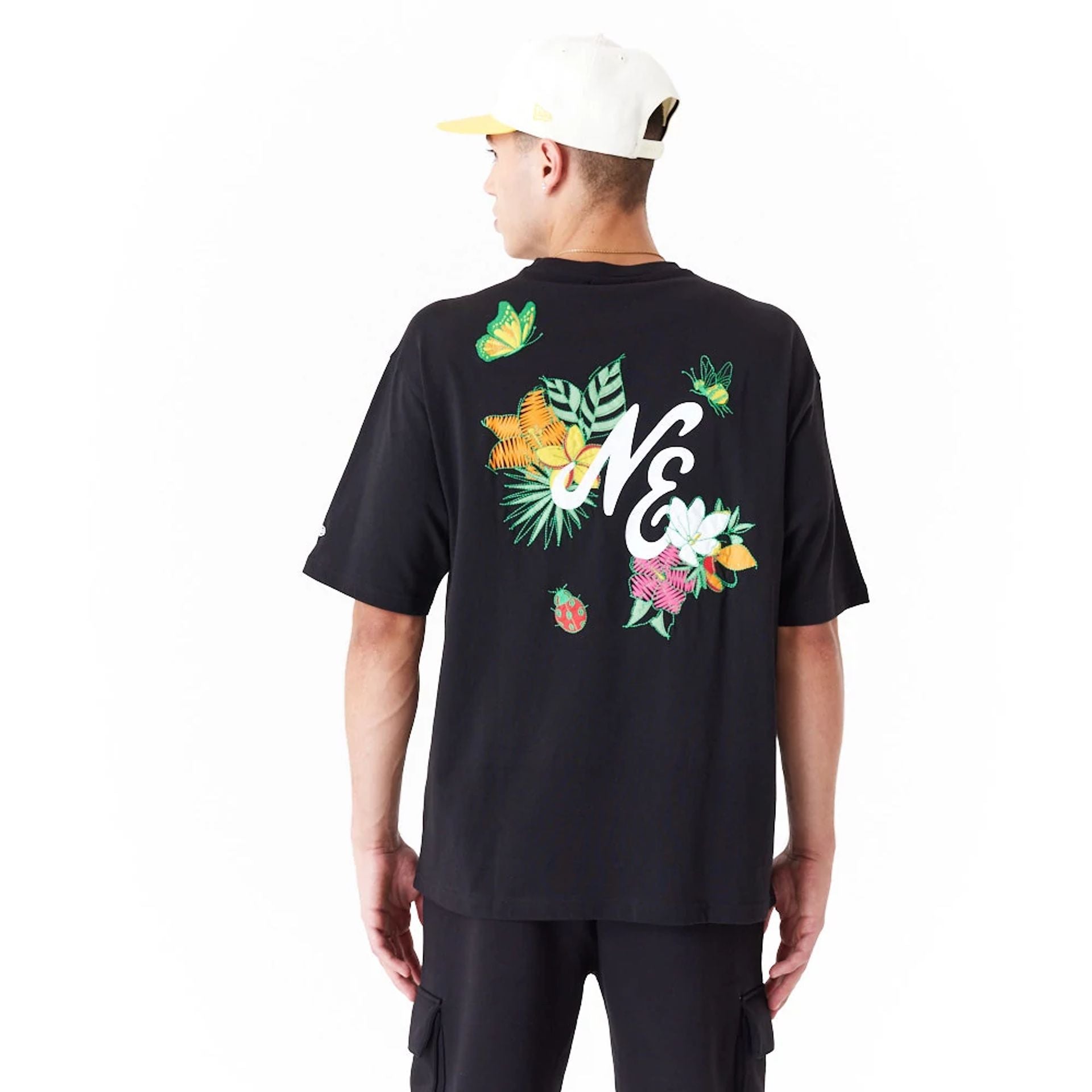 The Male model is wearing New Era Floral Graphic Black Oversized T-Shirt 3