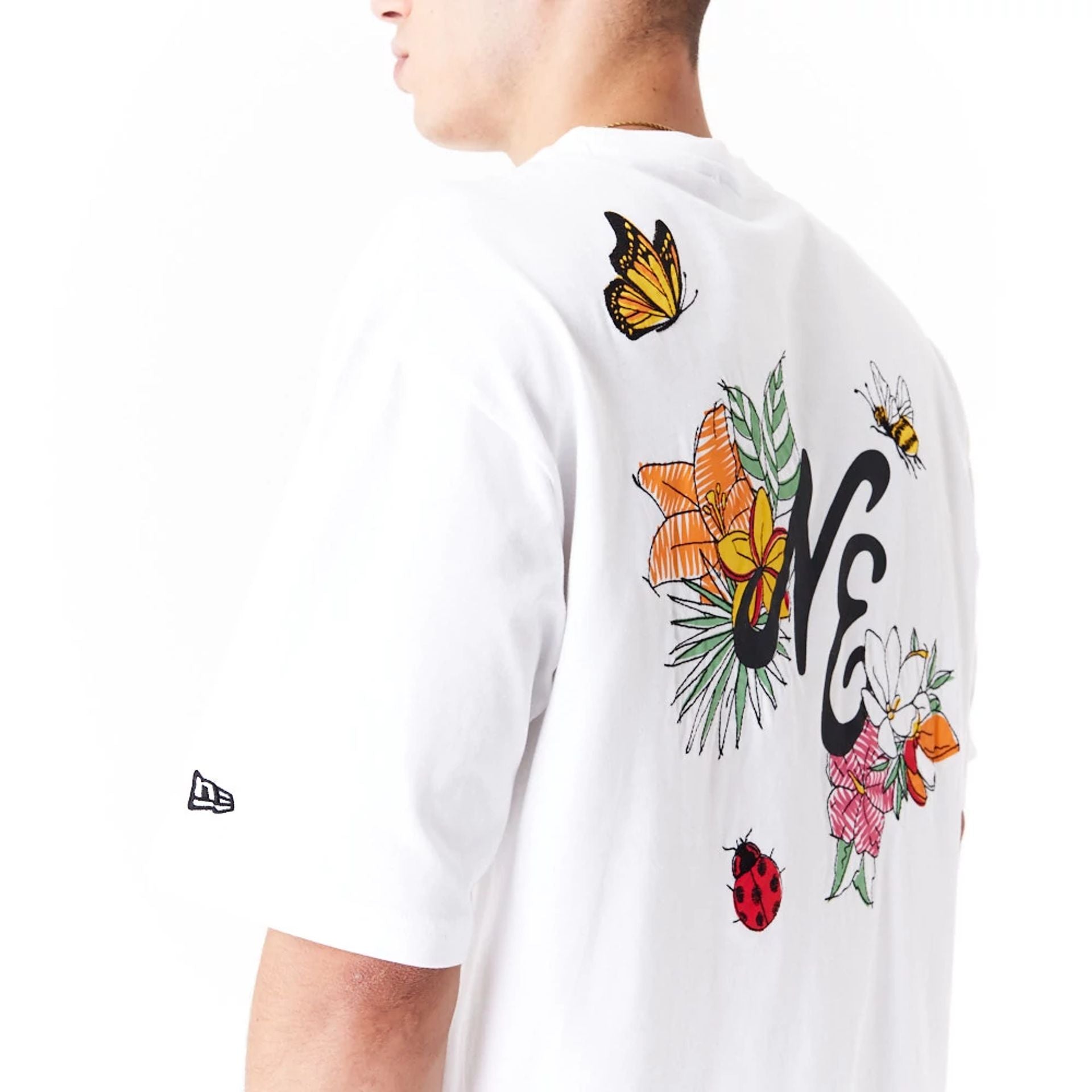 The Male model is wearing New Era Floral Graphic White Oversized T-Shirt 4