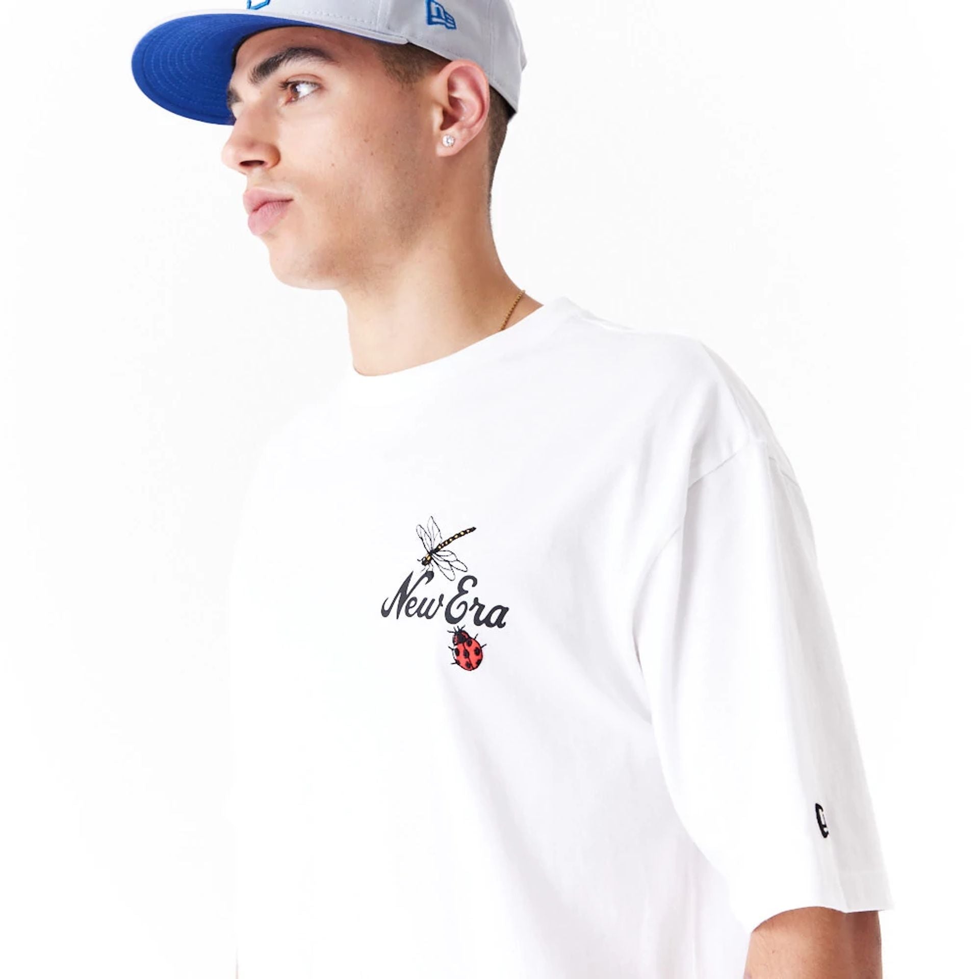 The Male model is wearing New Era Floral Graphic White Oversized T-Shirt 5