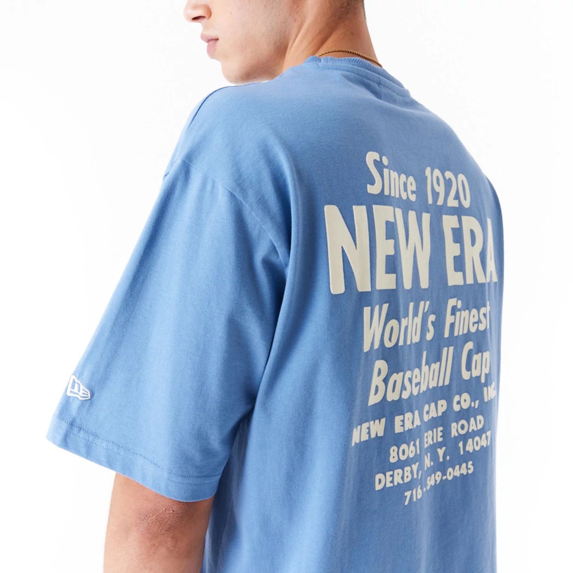 The Male model is wearing New Era Graphic Blue Oversized T-Shirt 6