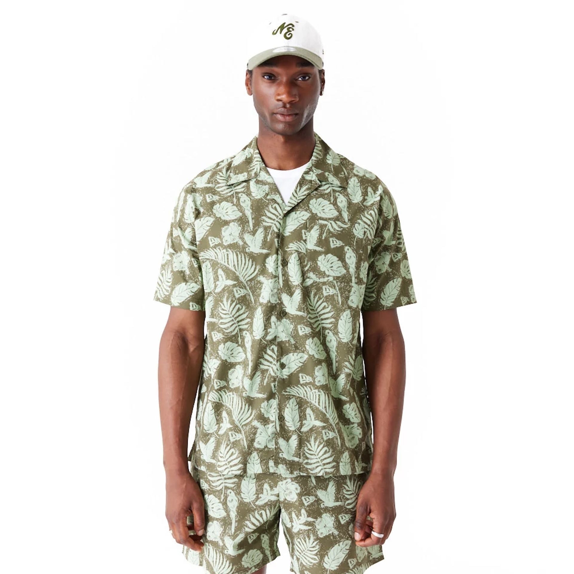 The Male model is wearing New Era All Over Print Green Woven Short Sleeve Shirt 1