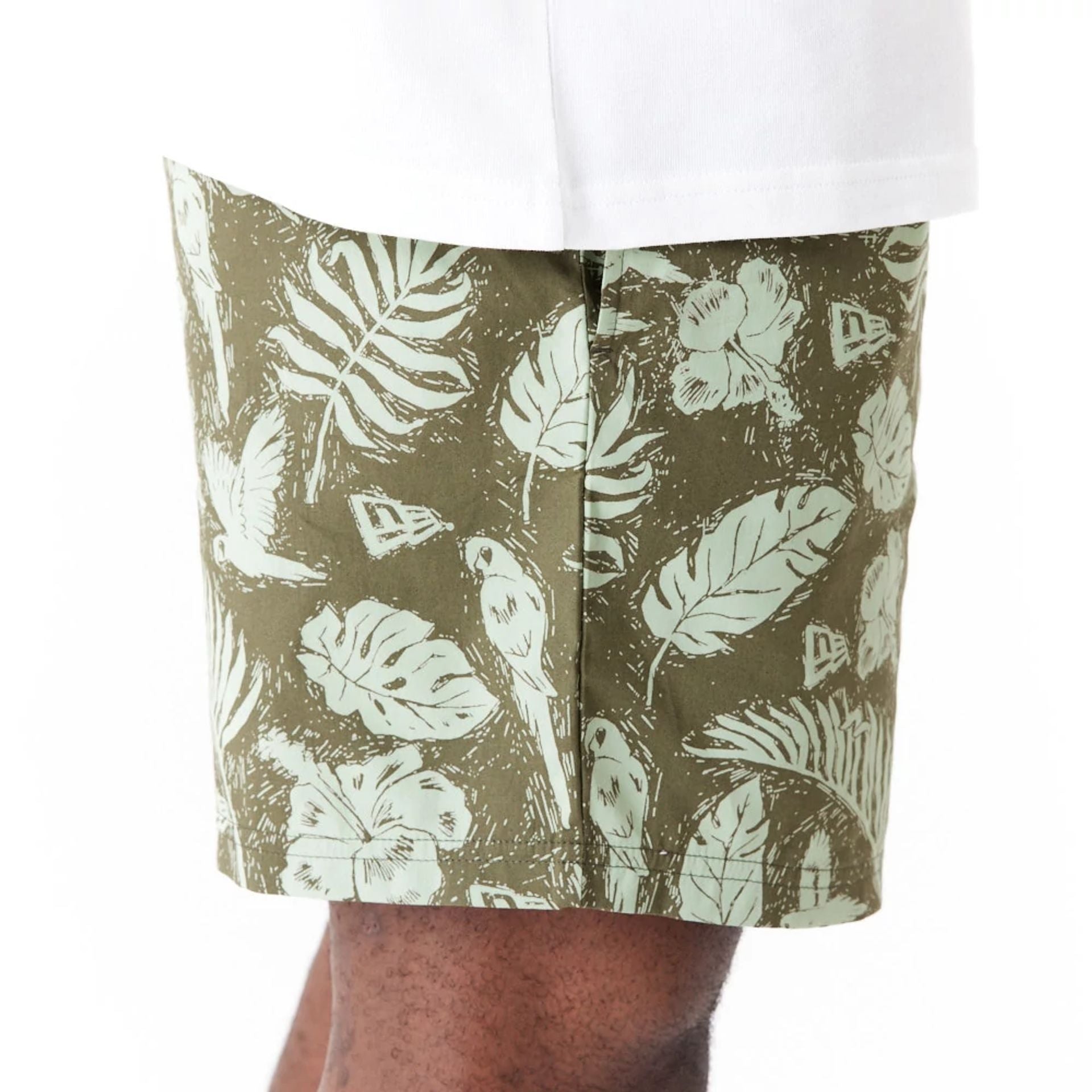 The Male model is wearing New Era All Over Print Green Woven Shorts 4