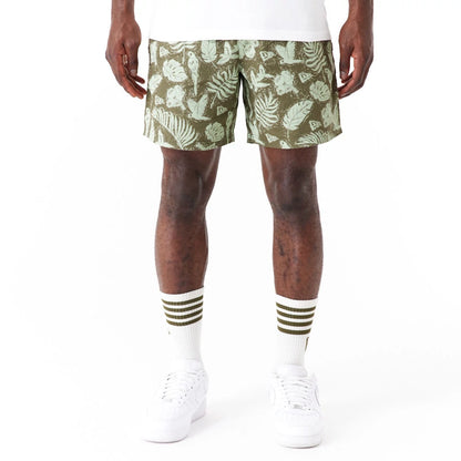 The Male model is wearing New Era All Over Print Green Woven Shorts 1