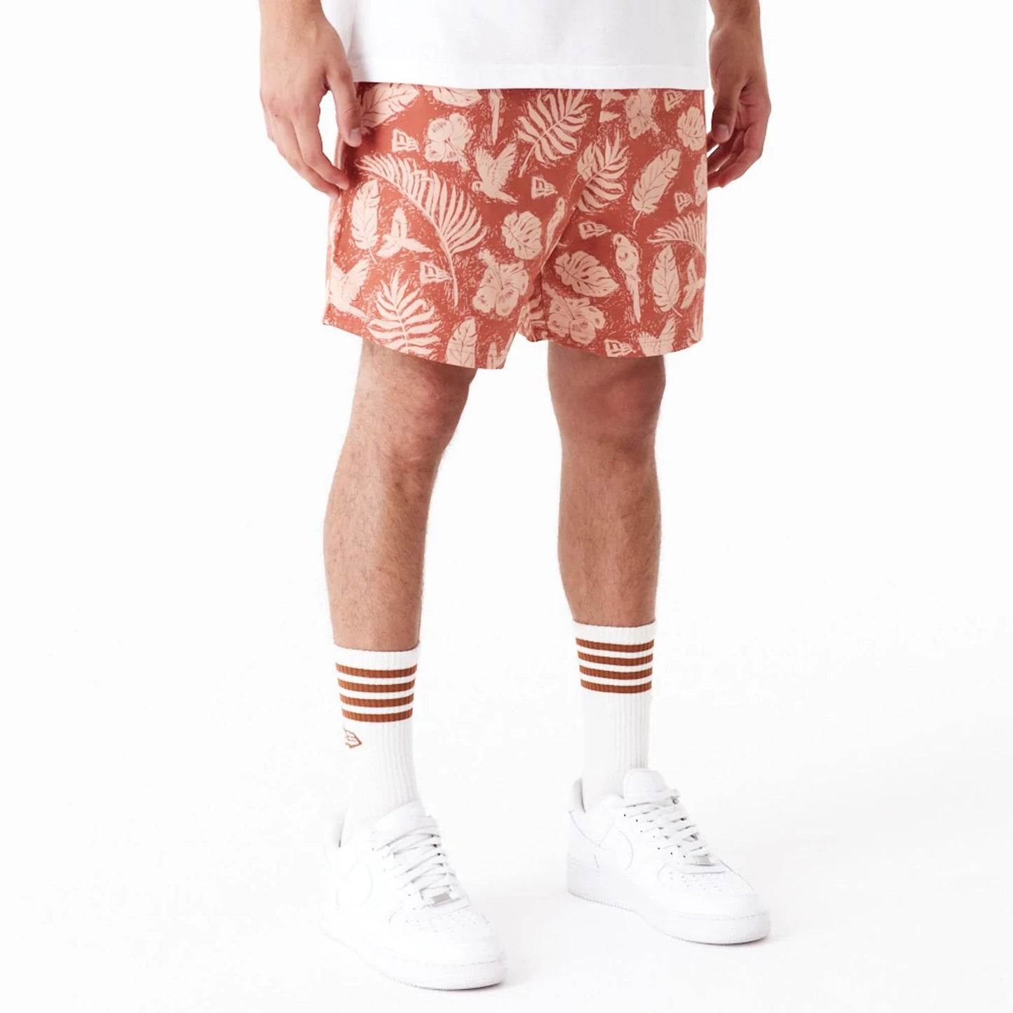 The Male model is wearing New Era All Over Print Brown Woven Shorts 2