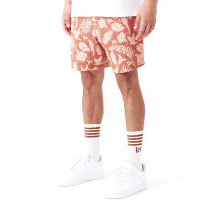 The Male model is wearing New Era All Over Print Brown Woven Shorts 5