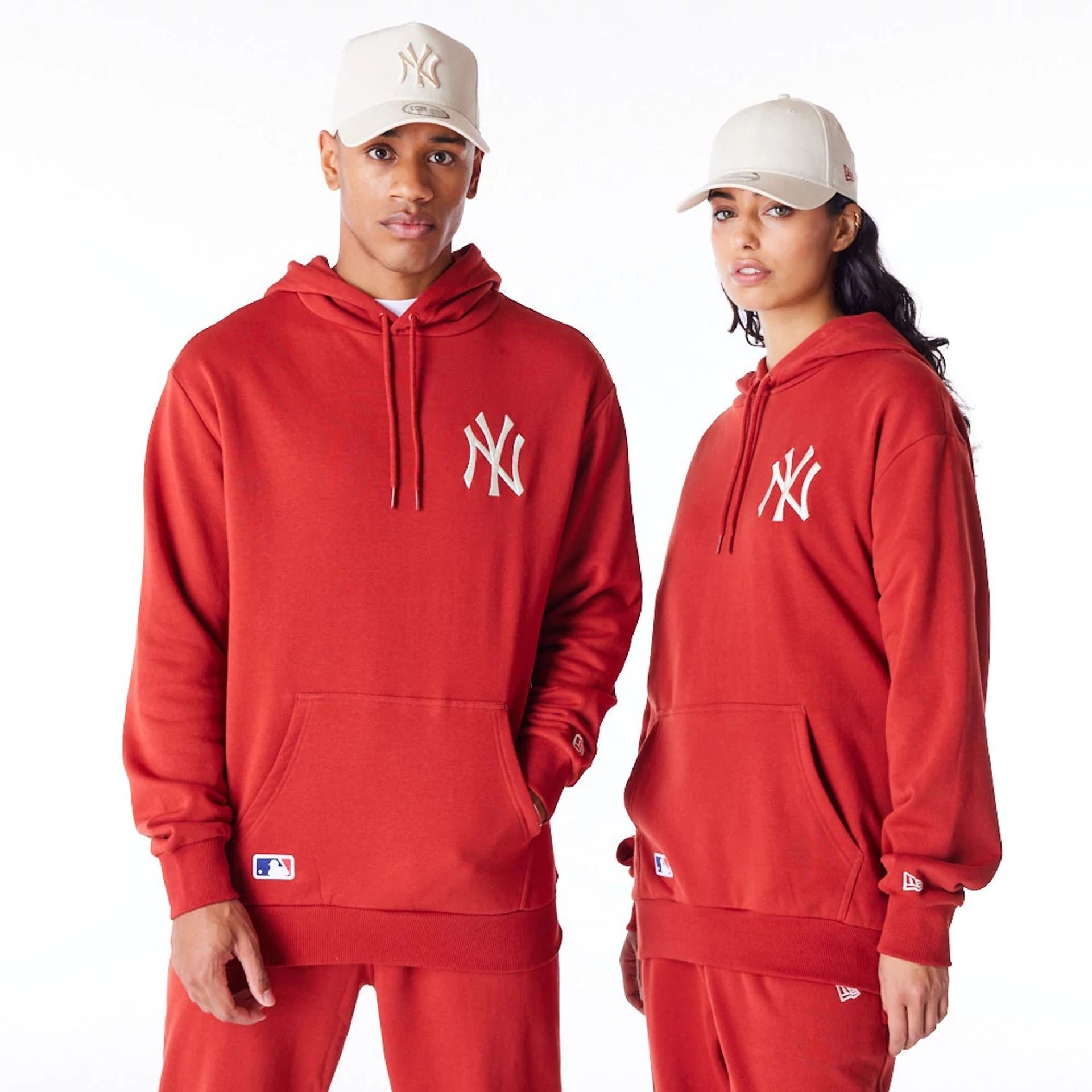 The Male model is wearing New York Yankees League Essential Red Oversized Pullover Hoodie 1