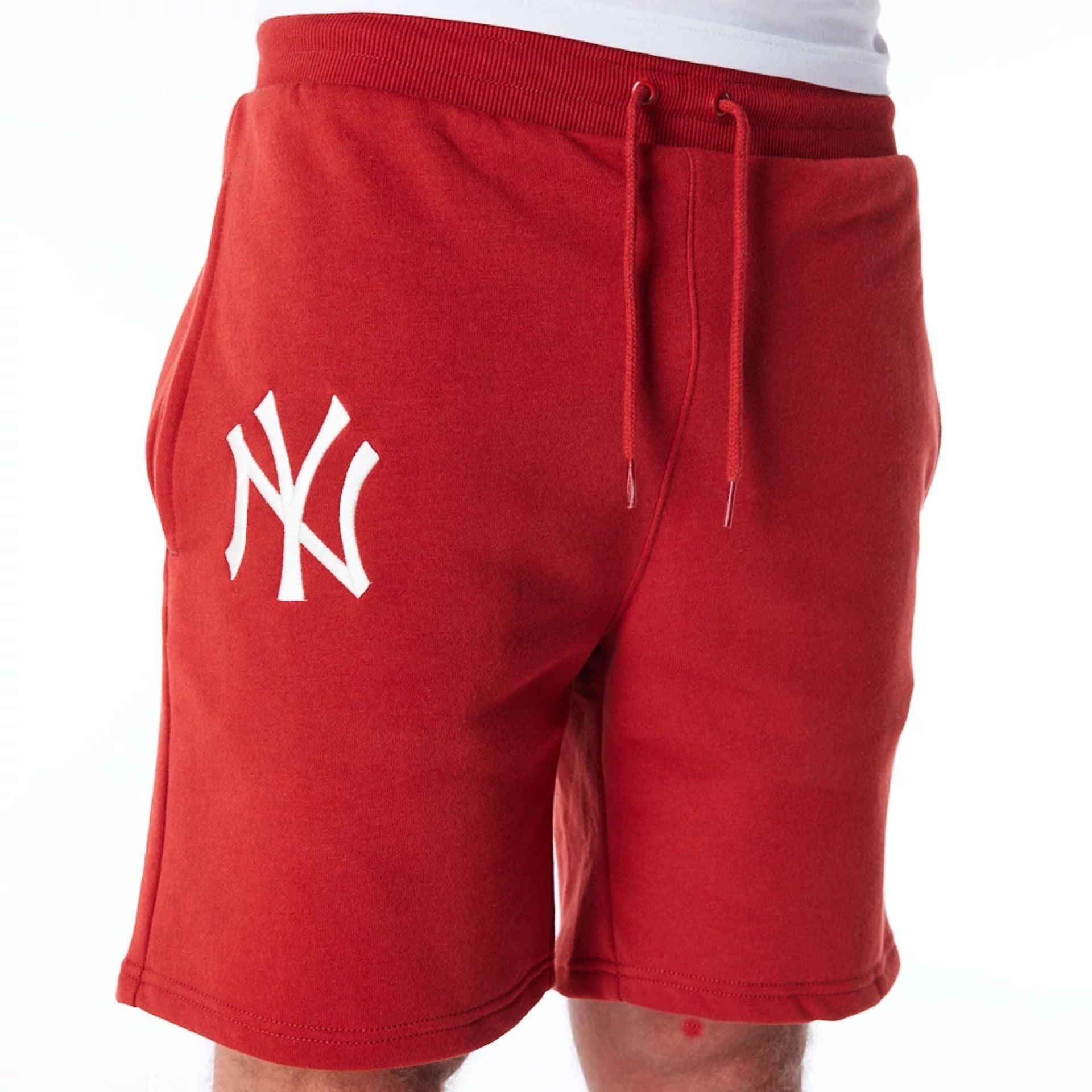 The Male model is wearing New York Yankees League Essential Red Shorts 5