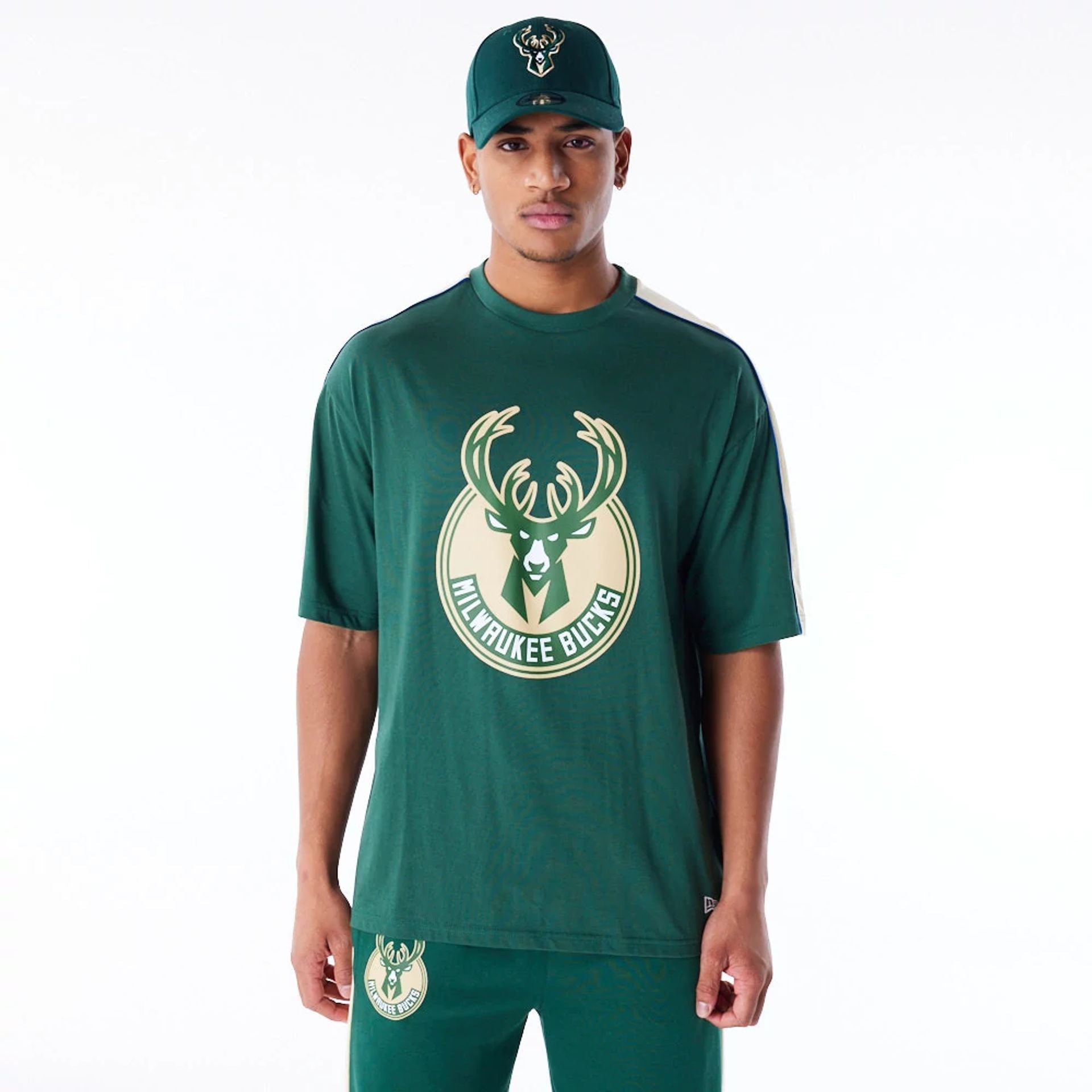 The Male model is wearing Milwaukee Bucks NBA Panel Dark Green Oversized T-Shirt 1