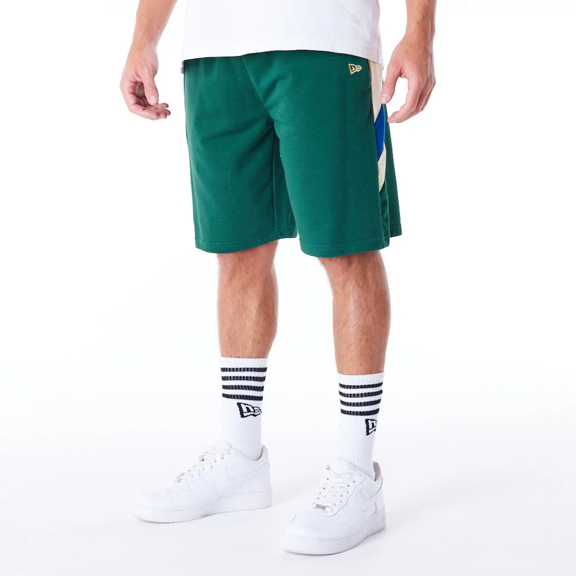 The Male model is wearing Milwaukee Bucks NBA Panel Dark Green Oversized Shorts 2