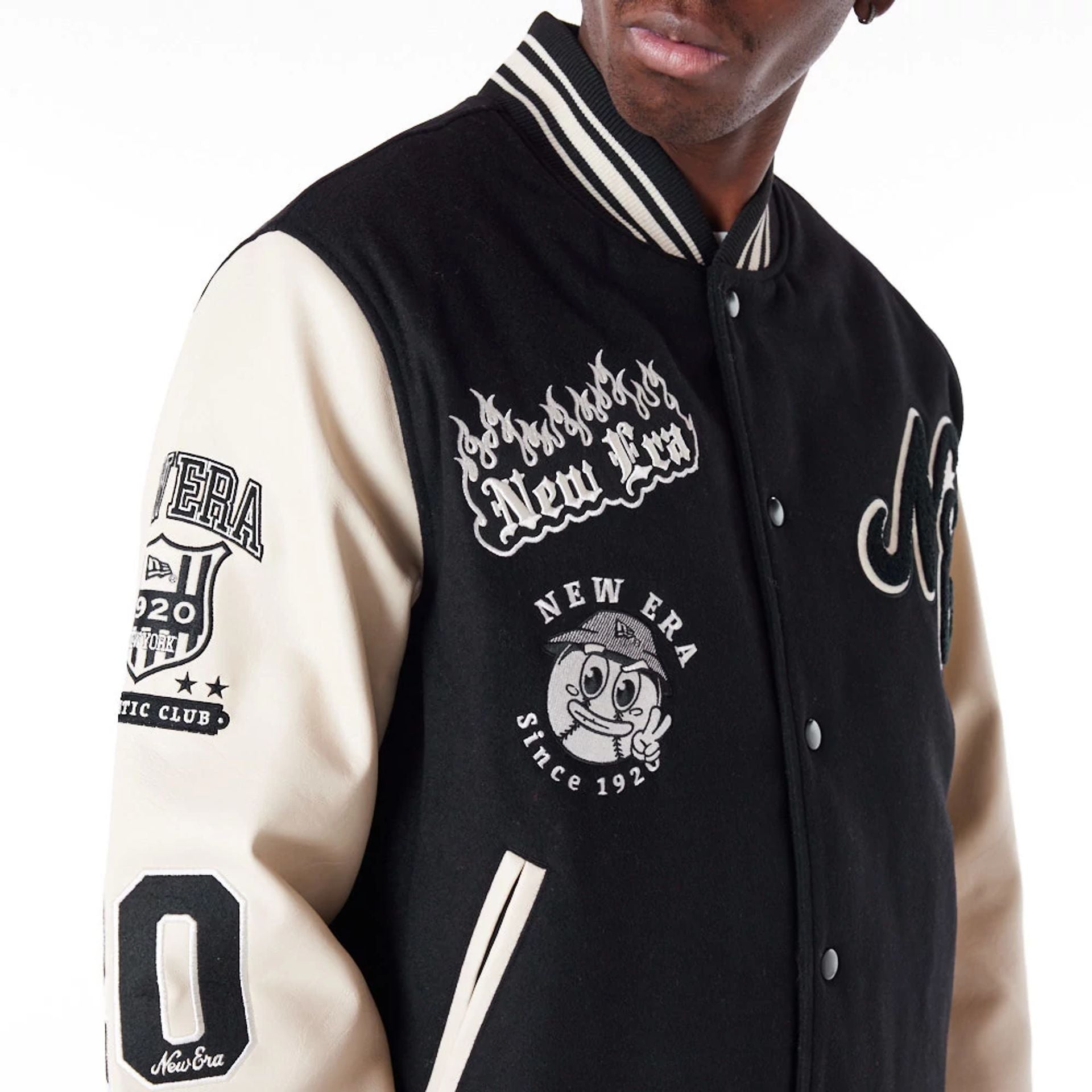 The Male model is wearing New Era Varisty Patch Black Varsity Jacket 4