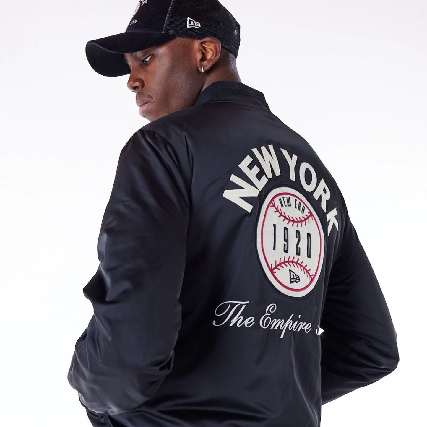 The Male model is wearing New Era Satin Graphic Black Bomber Jacket 8