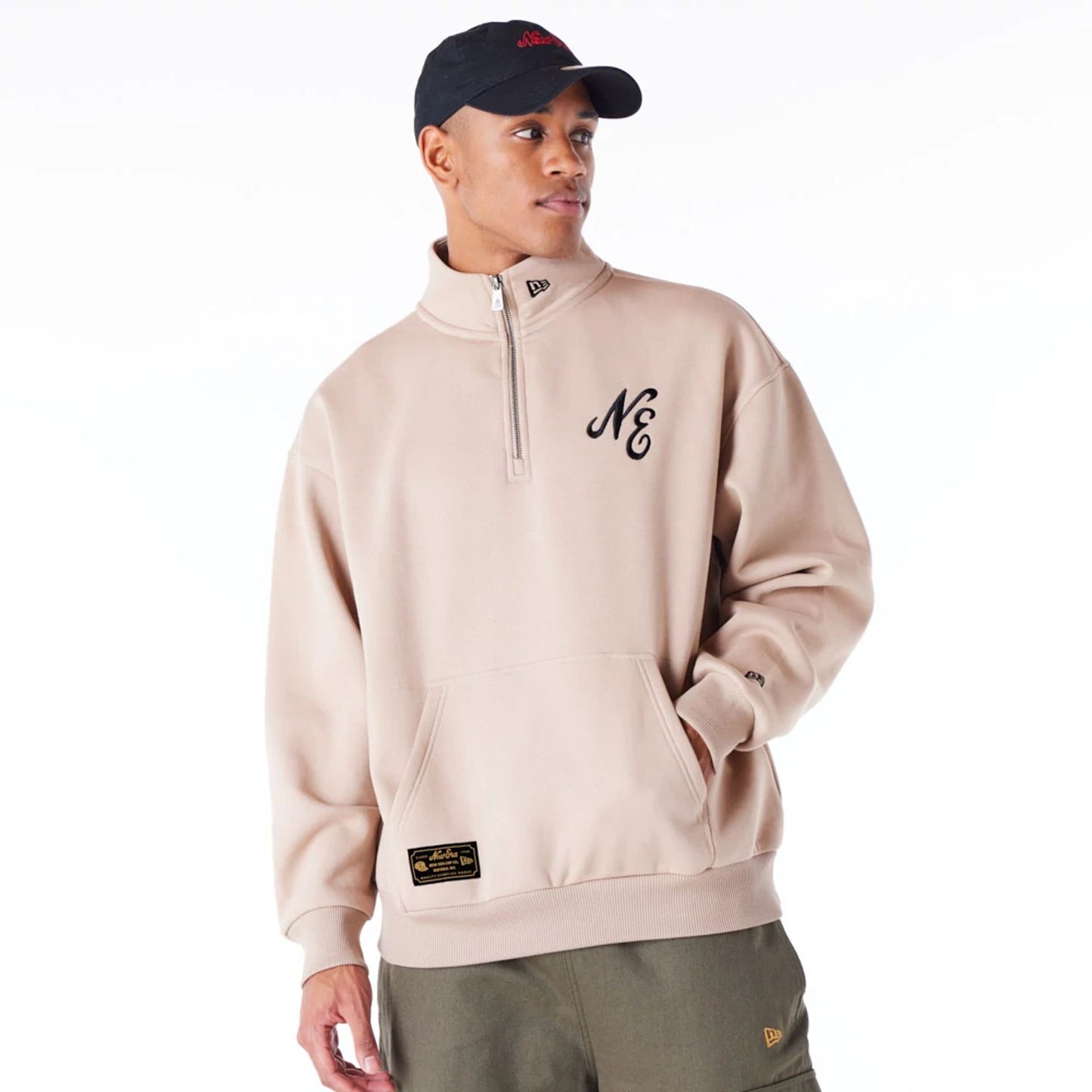 The Male model is wearing New Era Lifestyle Beige Quarter-Zip Sweater 1