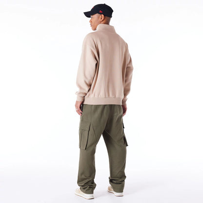 The Male model is wearing New Era Lifestyle Beige Quarter-Zip Sweater 9