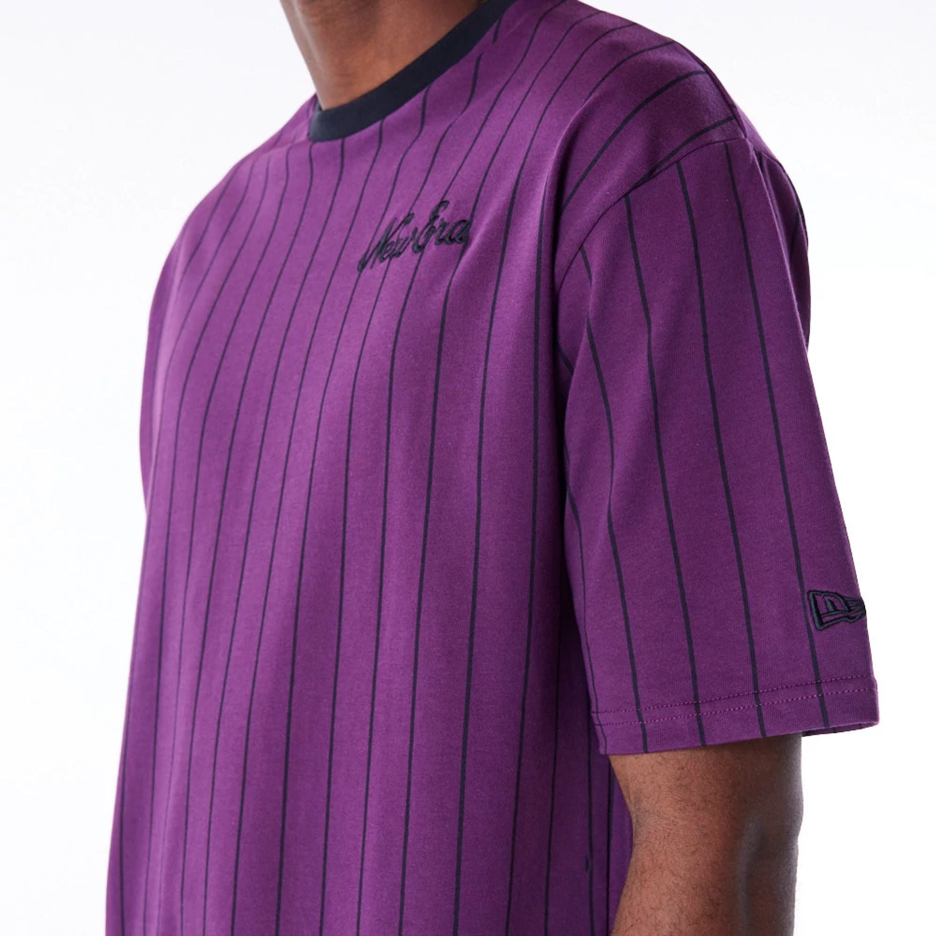 The Male model is wearing New Era Pinstripe Dark Purple Oversized T-Shirt 3