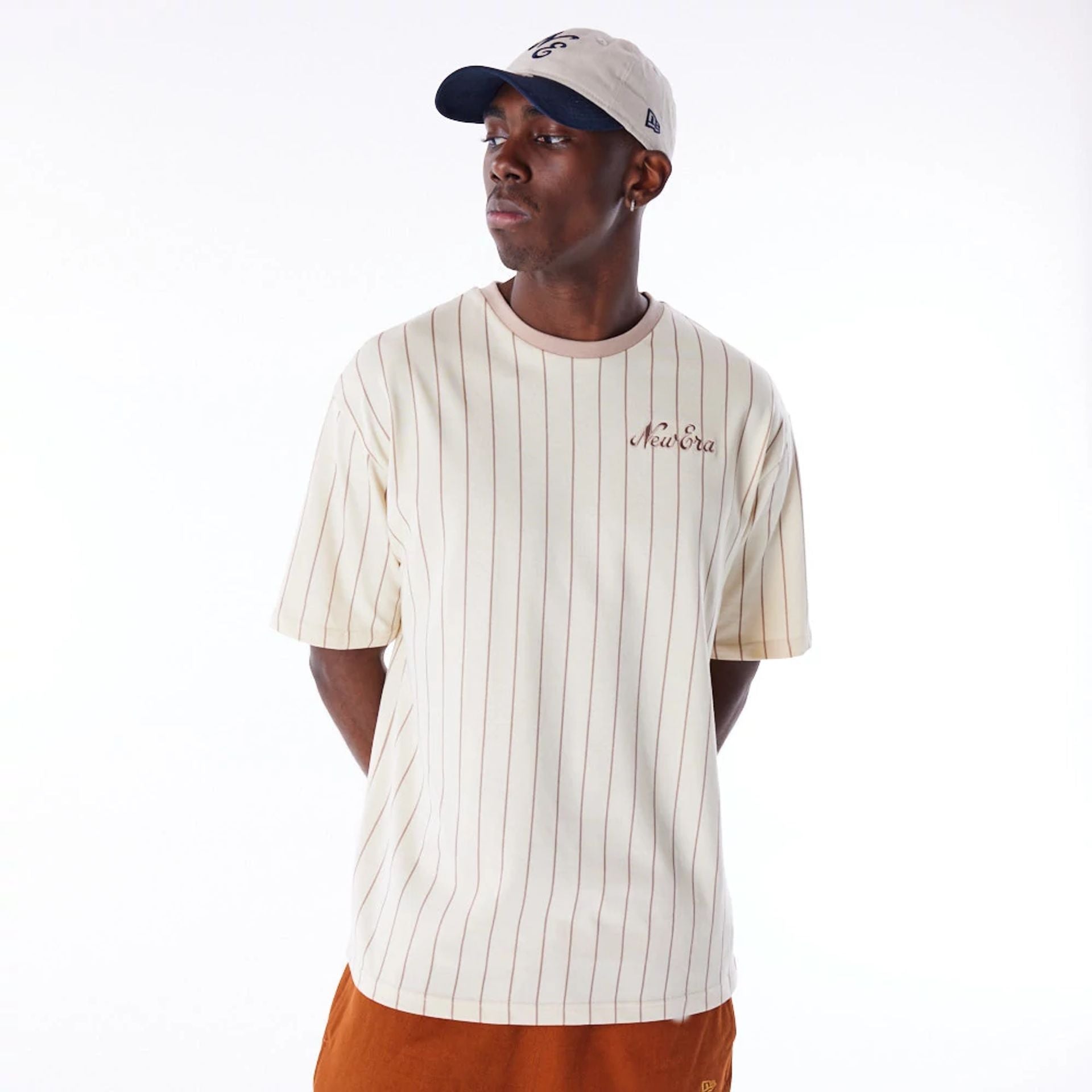 The Male model is wearing New Era Pinstripe Stone Oversized T-Shirt 1