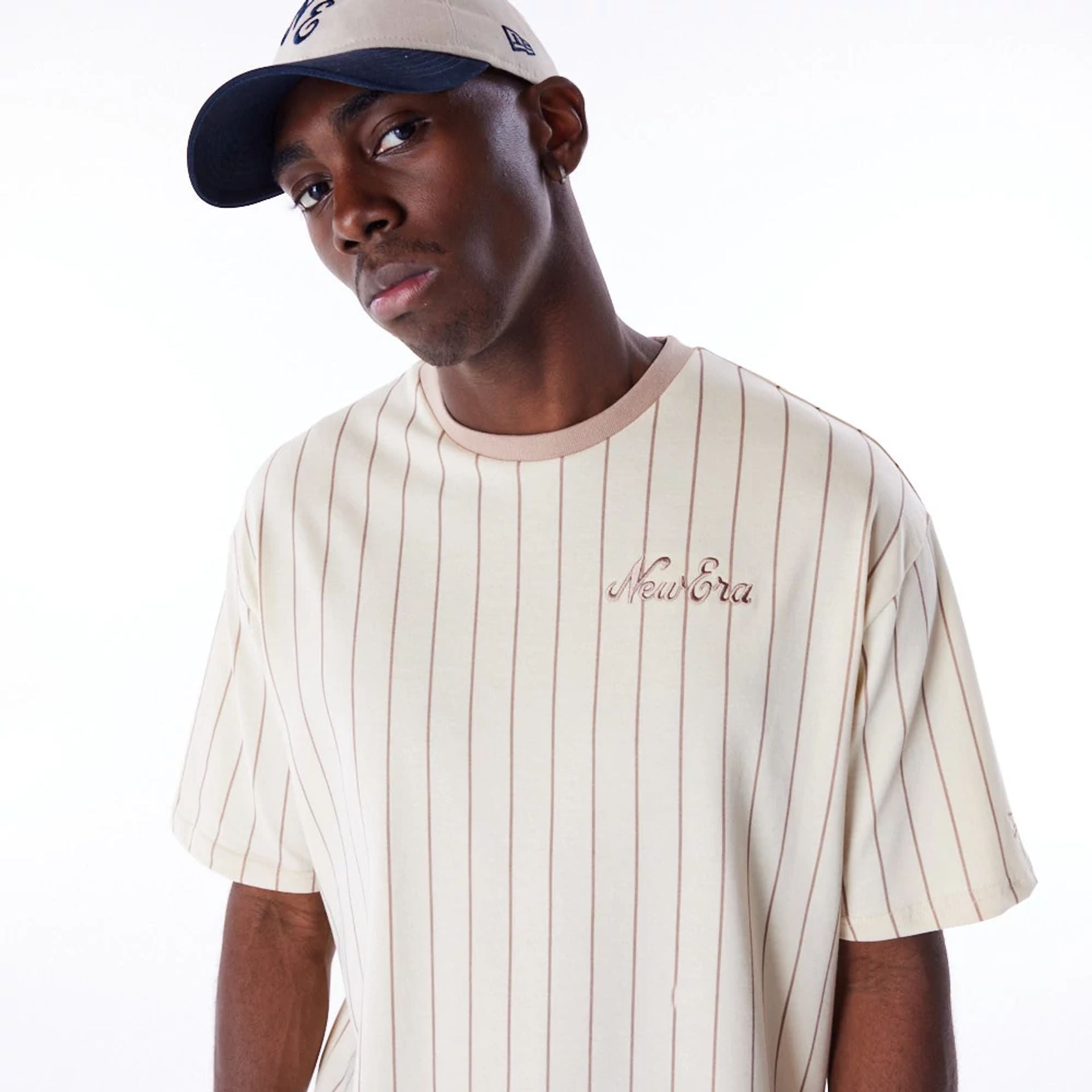 The Male model is wearing New Era Pinstripe Stone Oversized T-Shirt 2