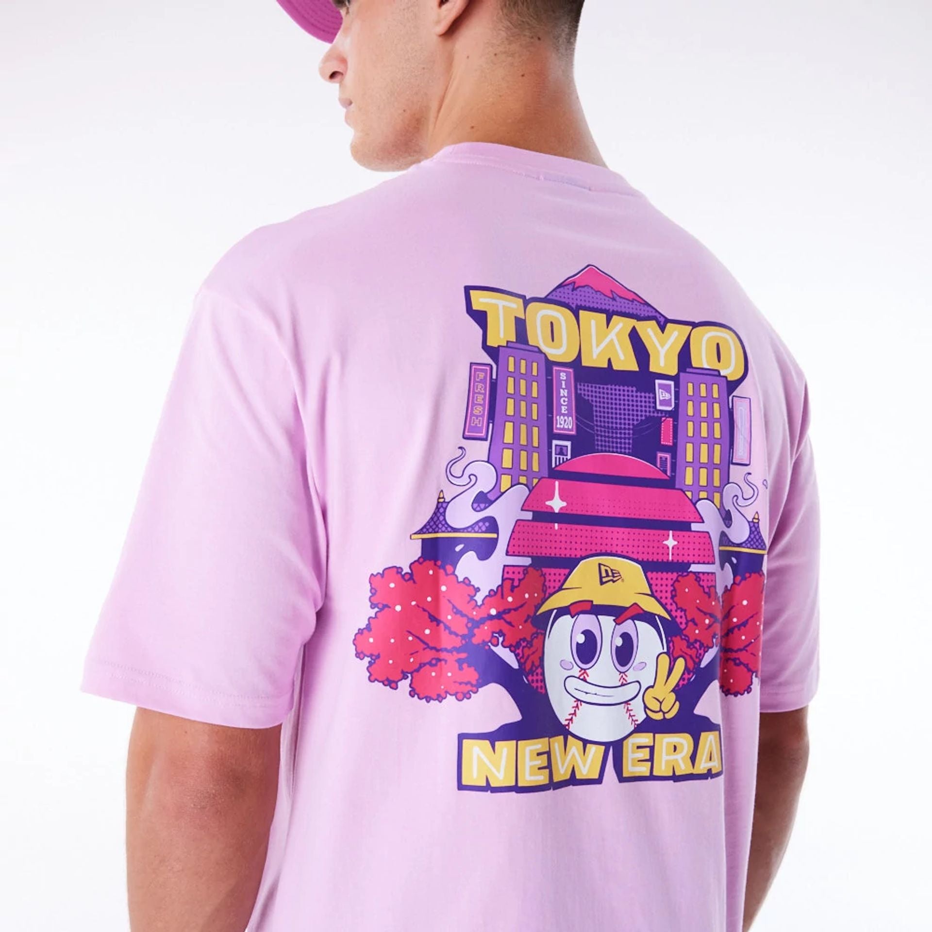 The Male model is wearing New Era Location Graphic Tokyo Pastel Pink Oversized T-Shirt 6