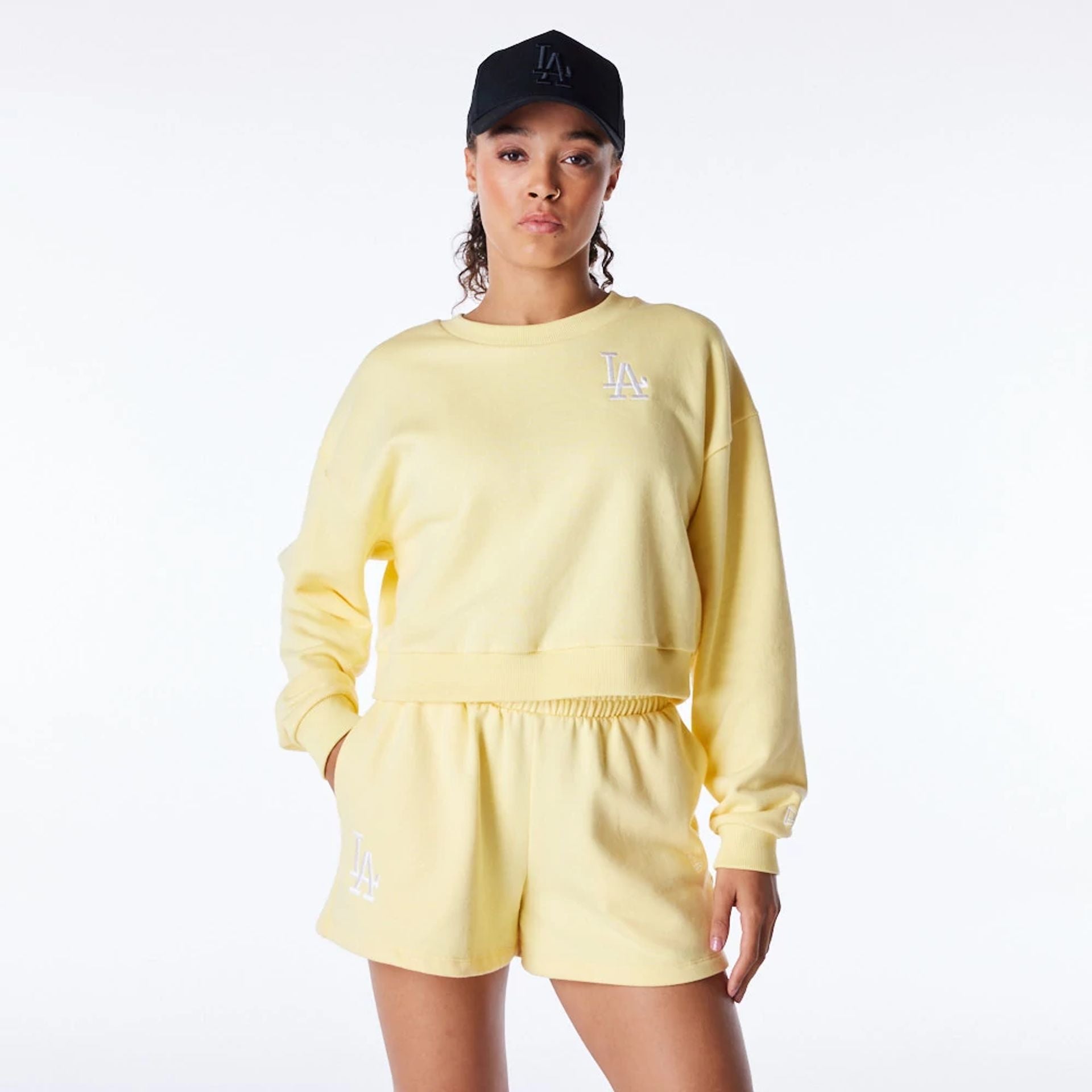 The Female model is wearing LA Dodgers Womens MLB League Essential Pastel Yellow Crop Crew Neck Sweatshirt 1