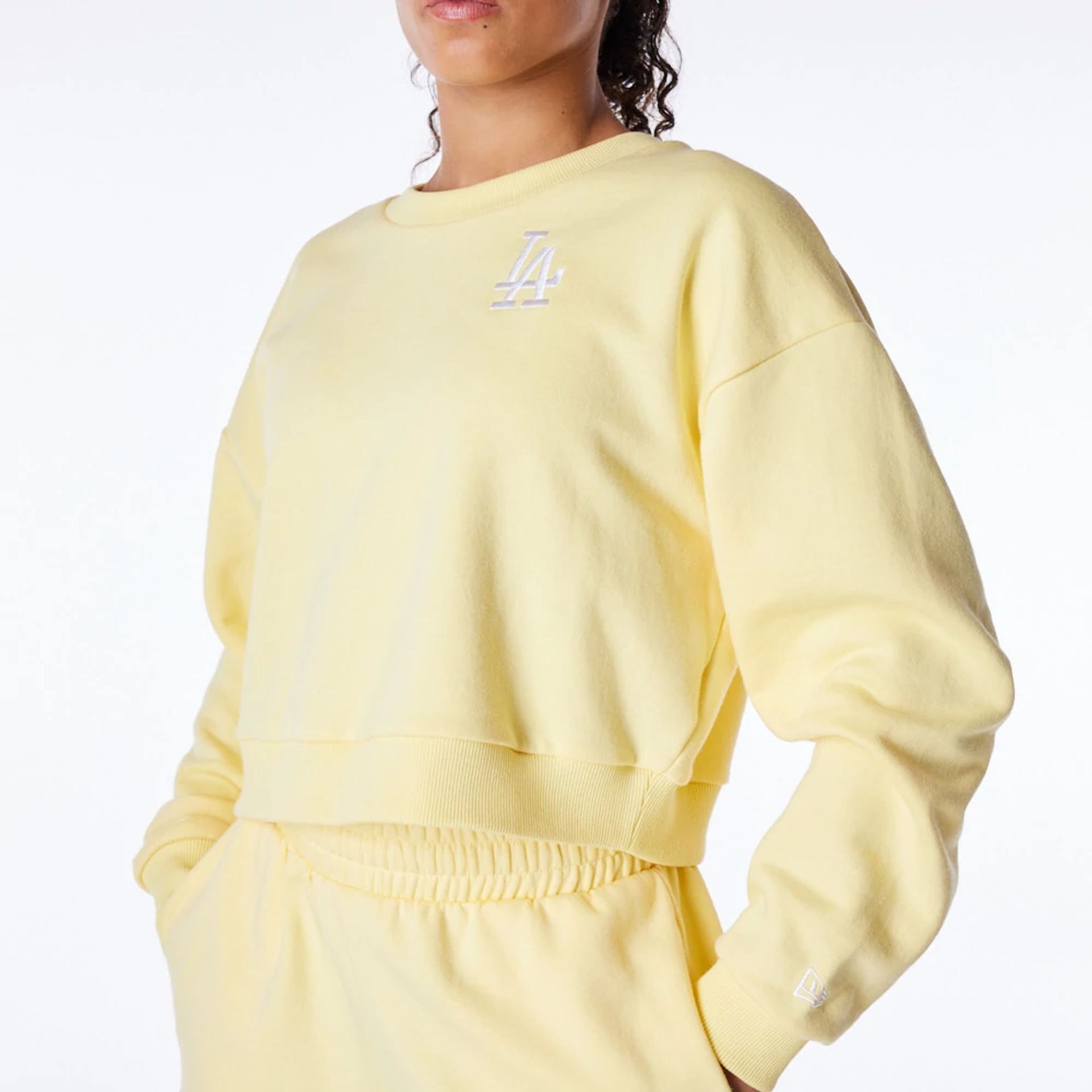 The Female model is wearing LA Dodgers Womens MLB League Essential Pastel Yellow Crop Crew Neck Sweatshirt 7