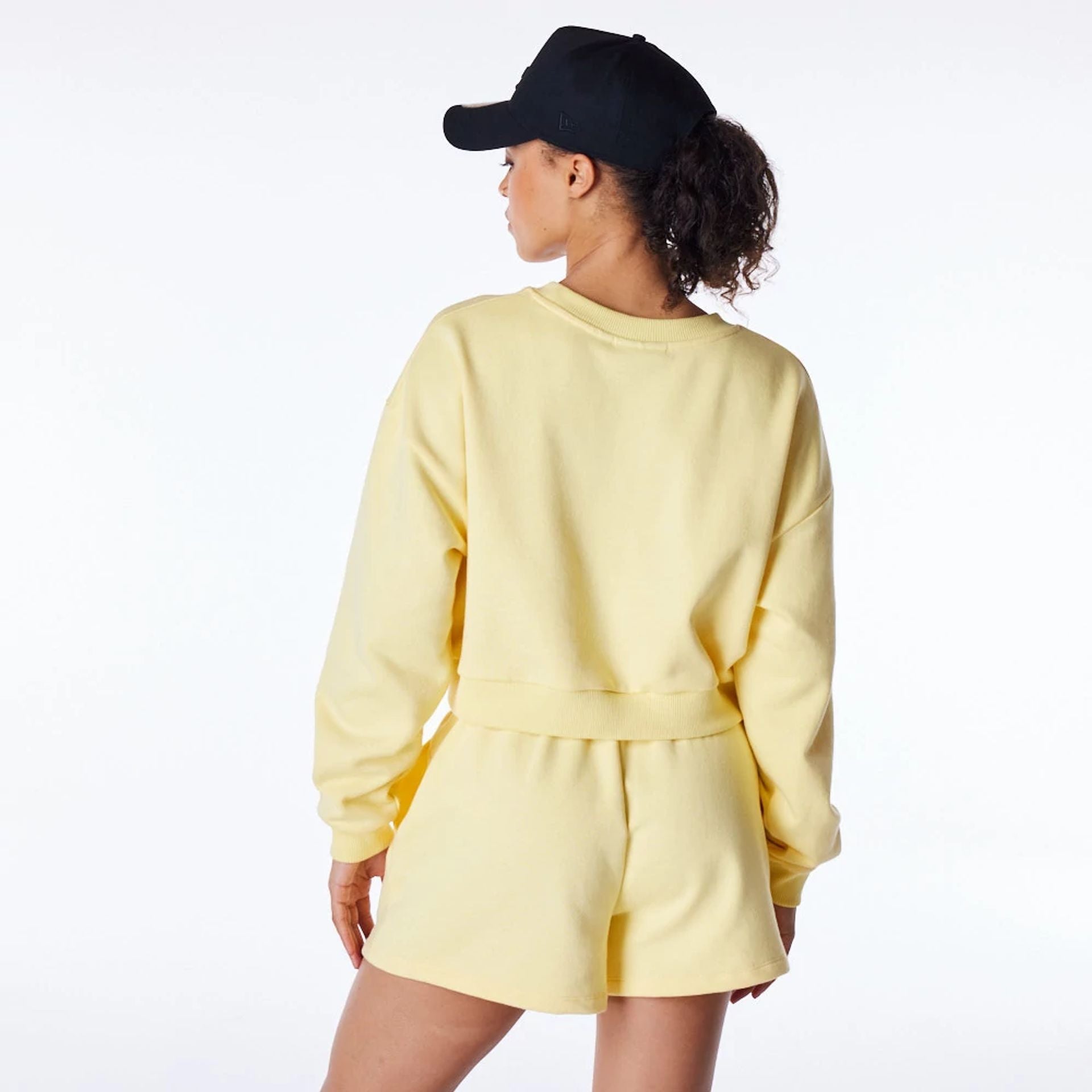 The Female model is wearing LA Dodgers Womens MLB League Essential Pastel Yellow Crop Crew Neck Sweatshirt 4