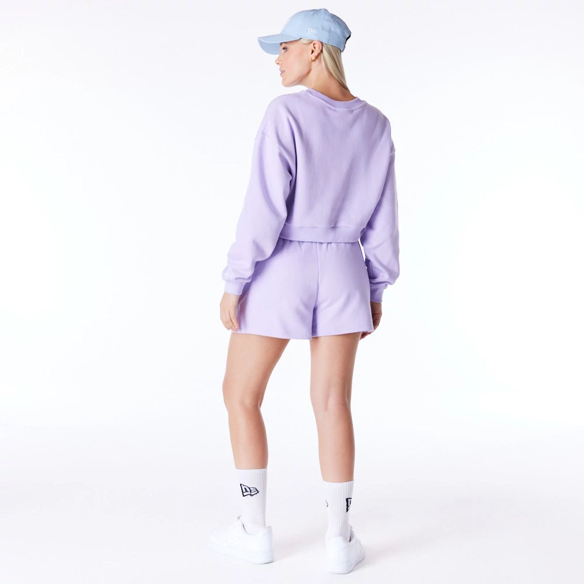 The Female model is wearing New York Yankees Womens MLB League Essential Pastel Purple Crop Crew Neck Sweatshirt 2