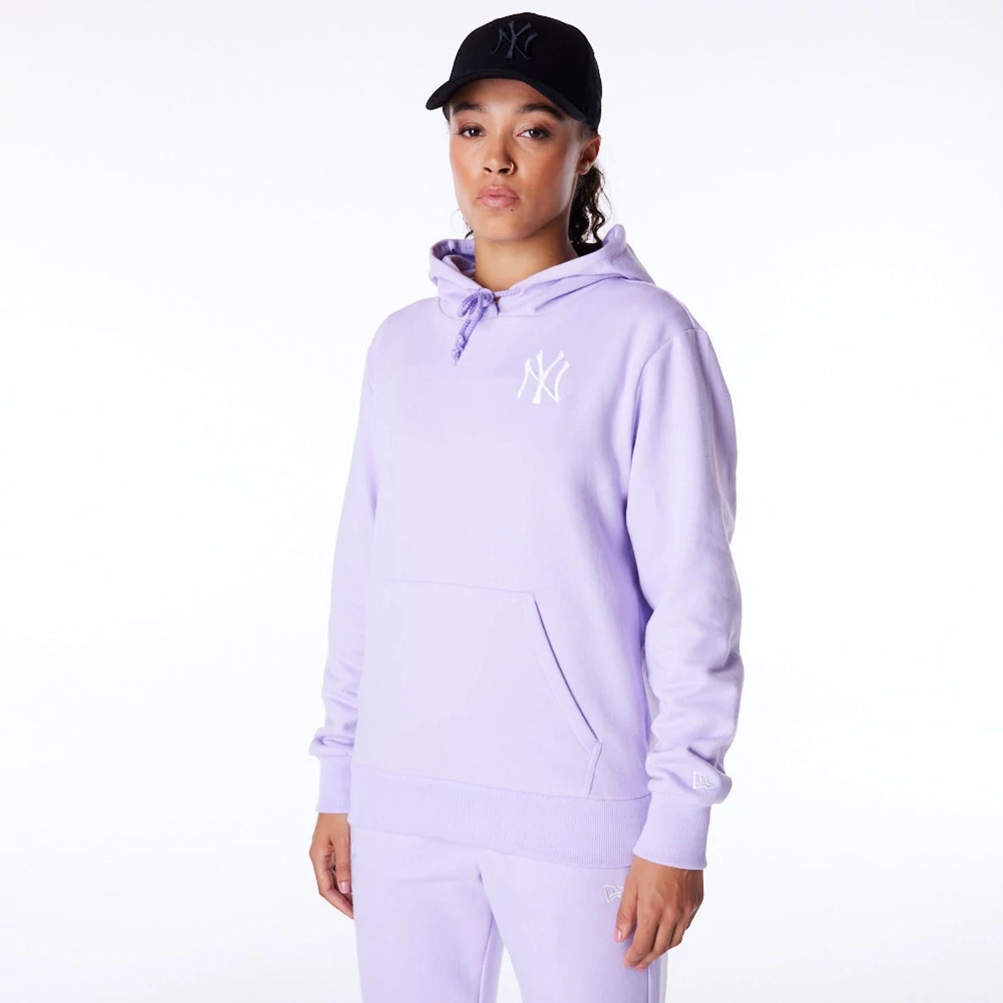 The Female model is wearing New York Yankees Womens MLB League Essential Pastel Purple Pullover Hoodie 1