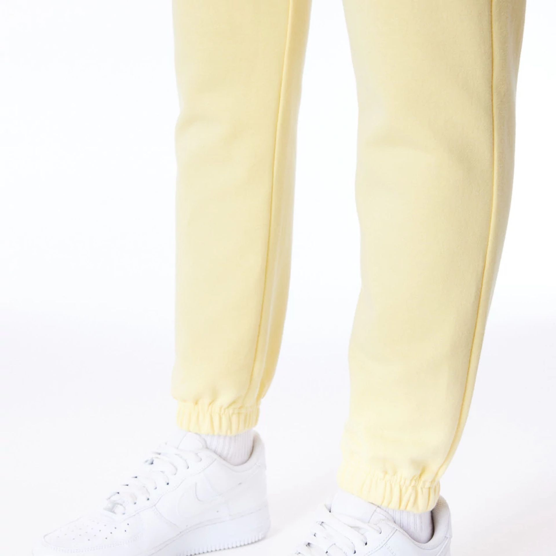 The Female model is wearing LA Dodgers Womens MLB League Essential Pastel Yellow Fleece Joggers 5