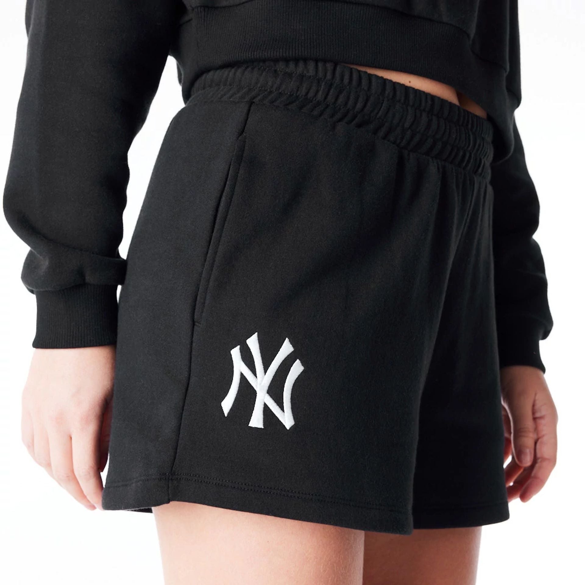 The Female model is wearing New York Yankees Womens MLB League Essential Black Shorts 1