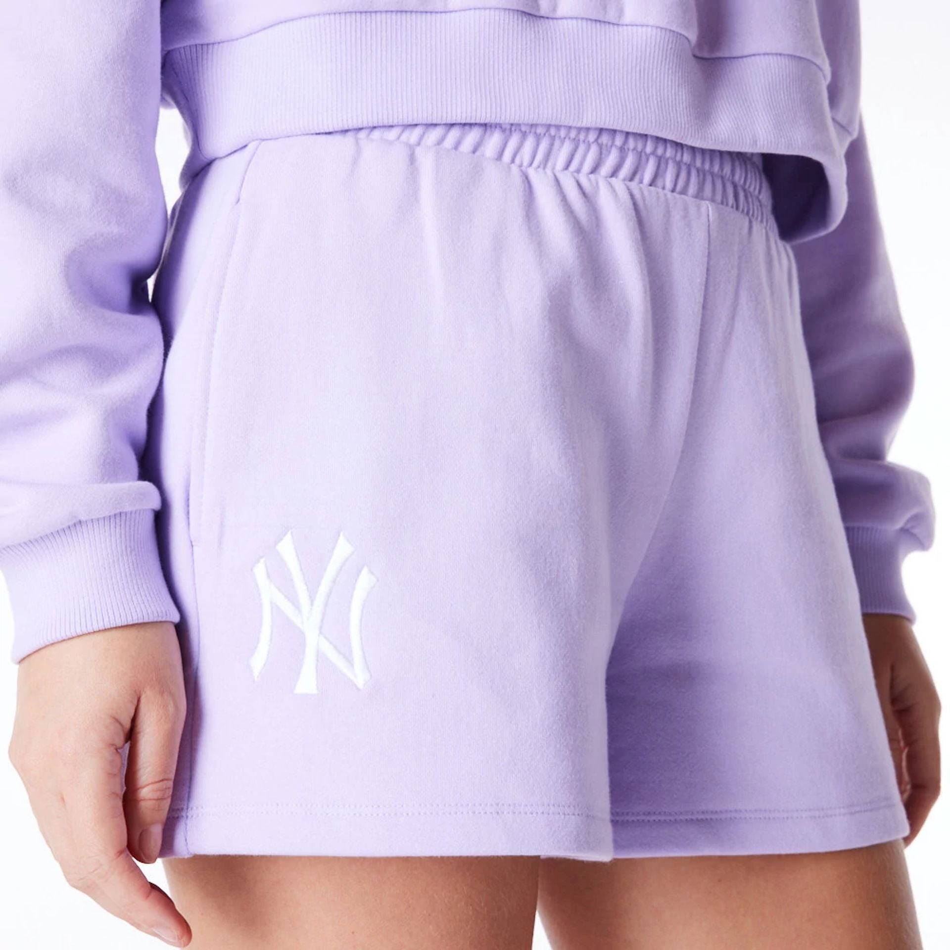 The Female model is wearing New York Yankees Womens MLB League Essential Pastel Purple Shorts 1