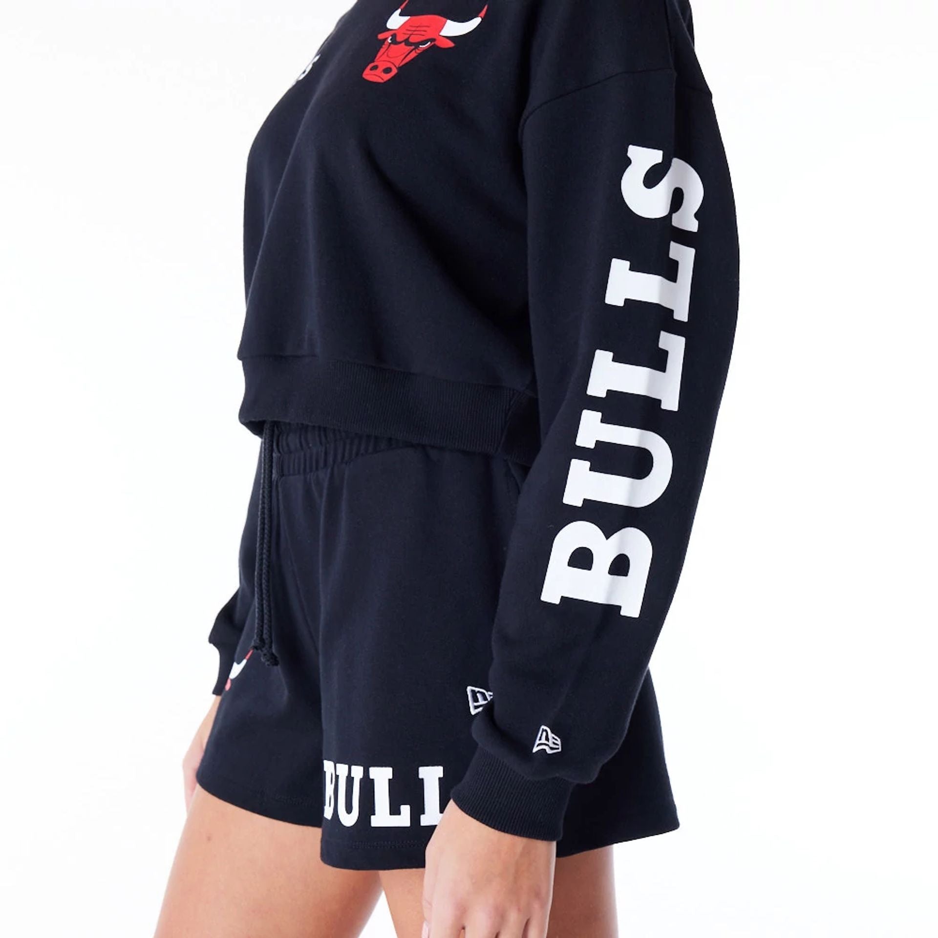 The Female model is wearing Chicago Bulls Womens NBA Wordmark Black Crop Crew Neck Sweatshirt 9