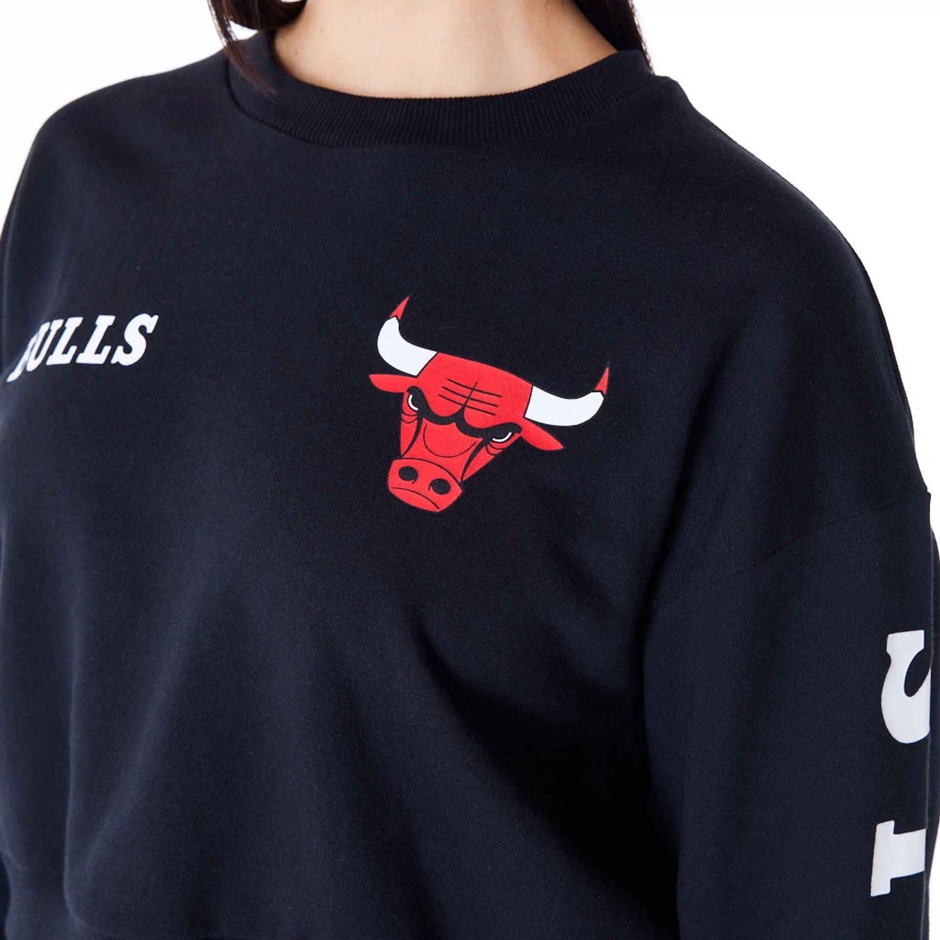 The Female model is wearing Chicago Bulls Womens NBA Wordmark Black Crop Crew Neck Sweatshirt 7