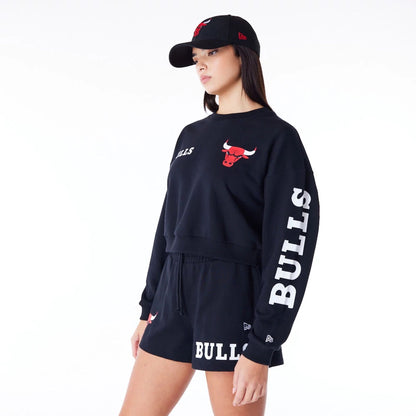 The Female model is wearing Chicago Bulls Womens NBA Wordmark Black Crop Crew Neck Sweatshirt 5