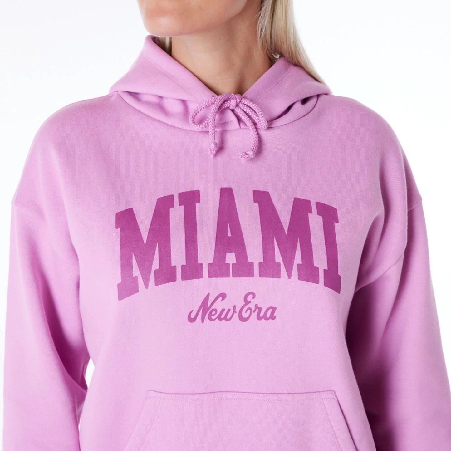 The Female model is wearing New Era Infill Pastel Pink Oversized Pullover Hoodie 4