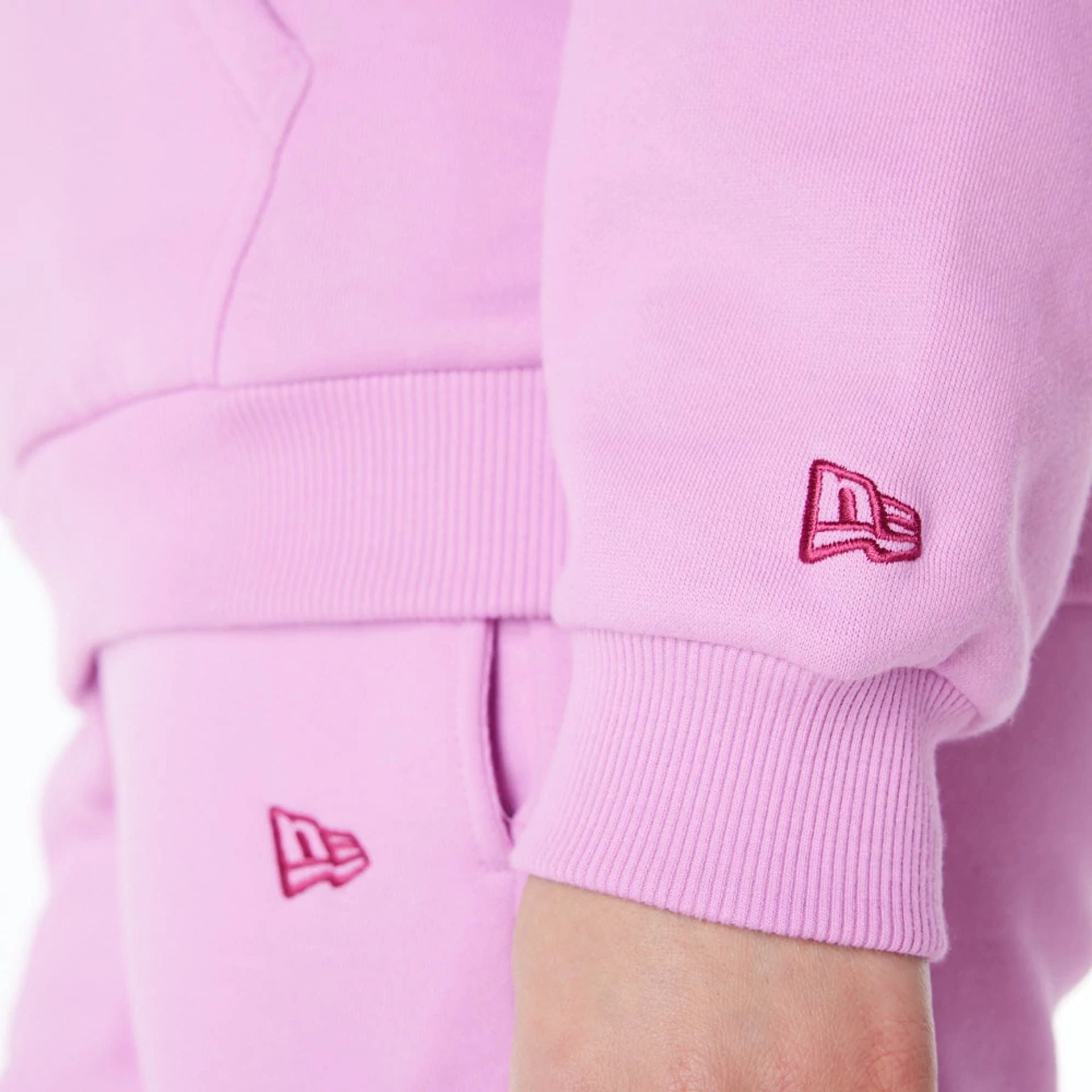 The Female model is wearing New Era Infill Pastel Pink Oversized Pullover Hoodie 5