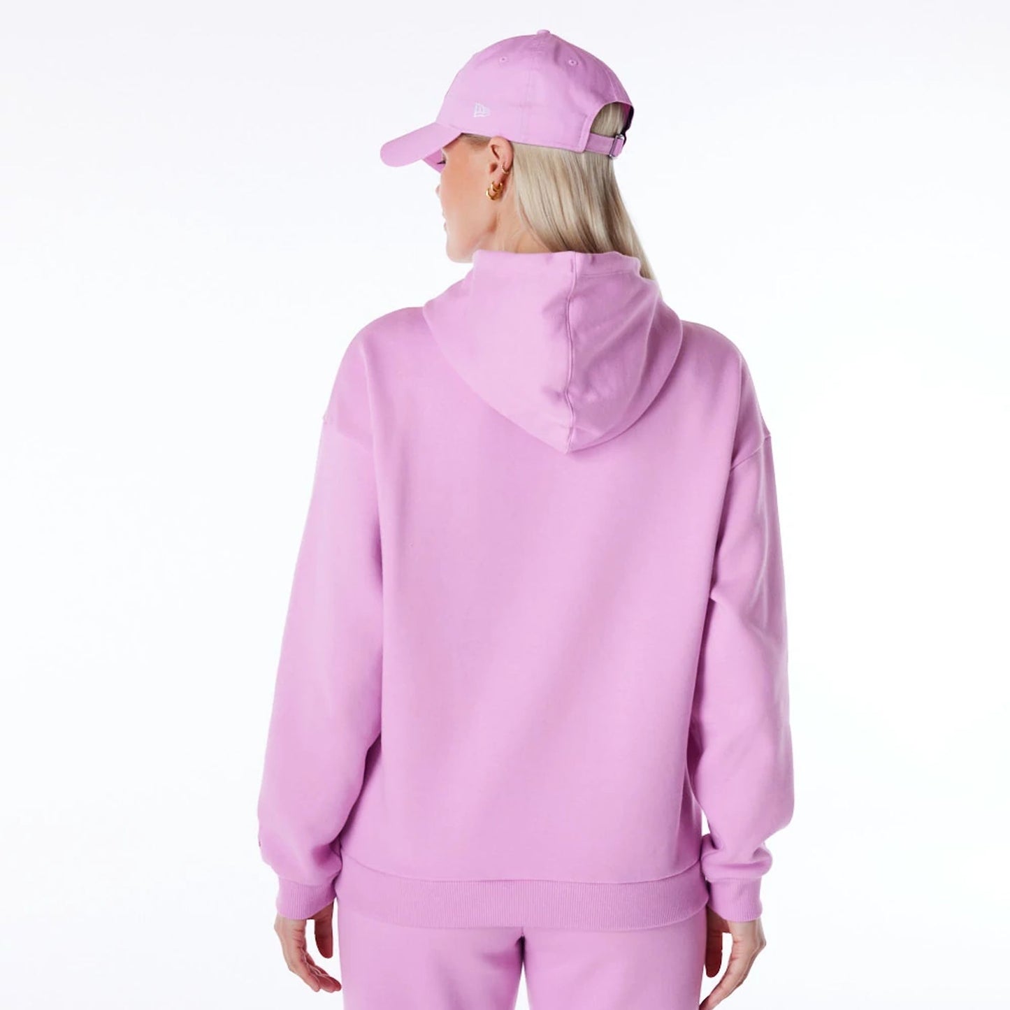 The Female model is wearing New Era Infill Pastel Pink Oversized Pullover Hoodie 3